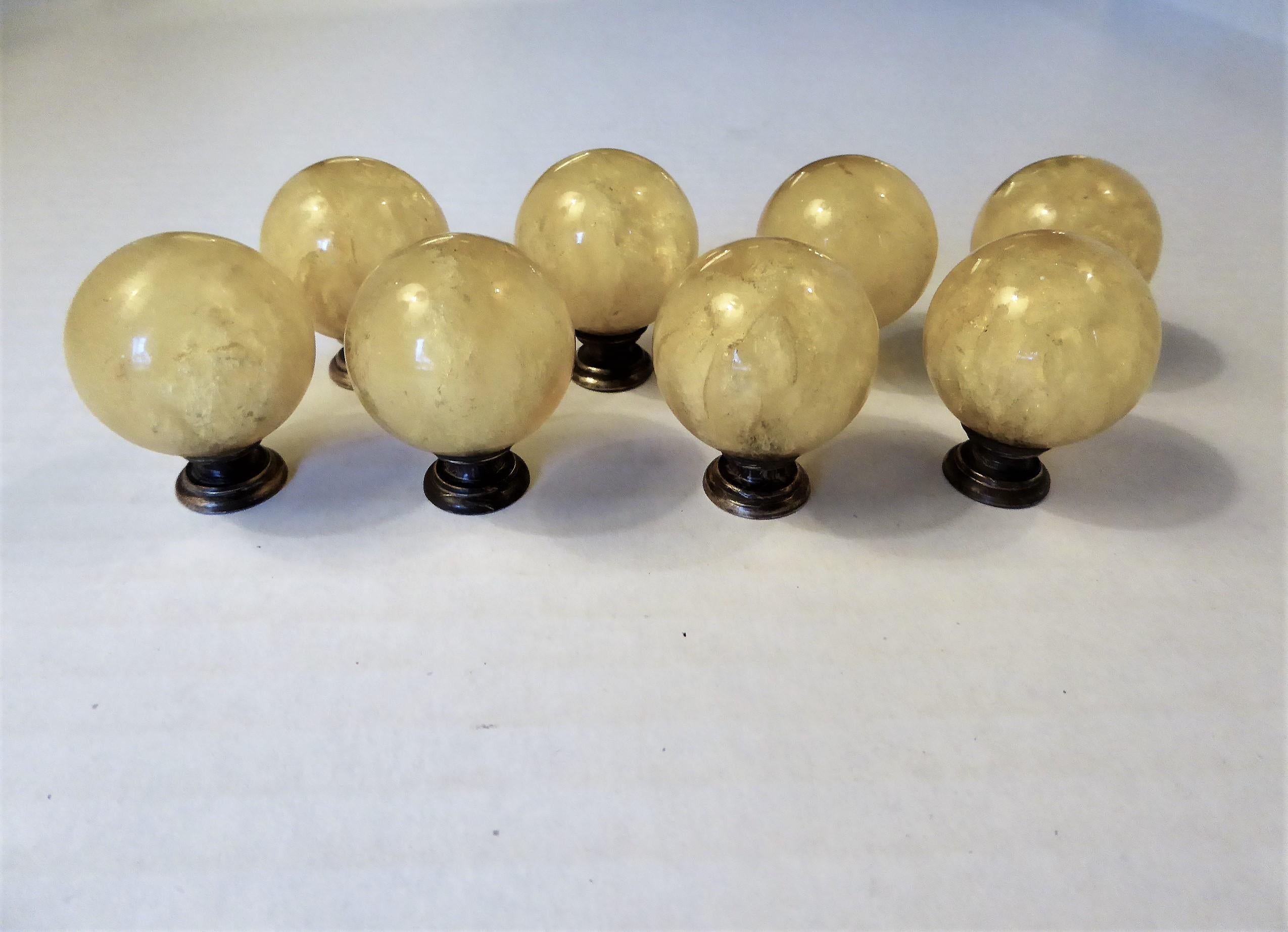 A Luxe set of eight Lucite drawer/cabinet pulls with bubbly inclusions by interior designer, architect and home builder Ruth Richmond of Sarasota, Florida. With dark brass mounts, the slightly amber Lucite balls have interior explosions of bubbles
