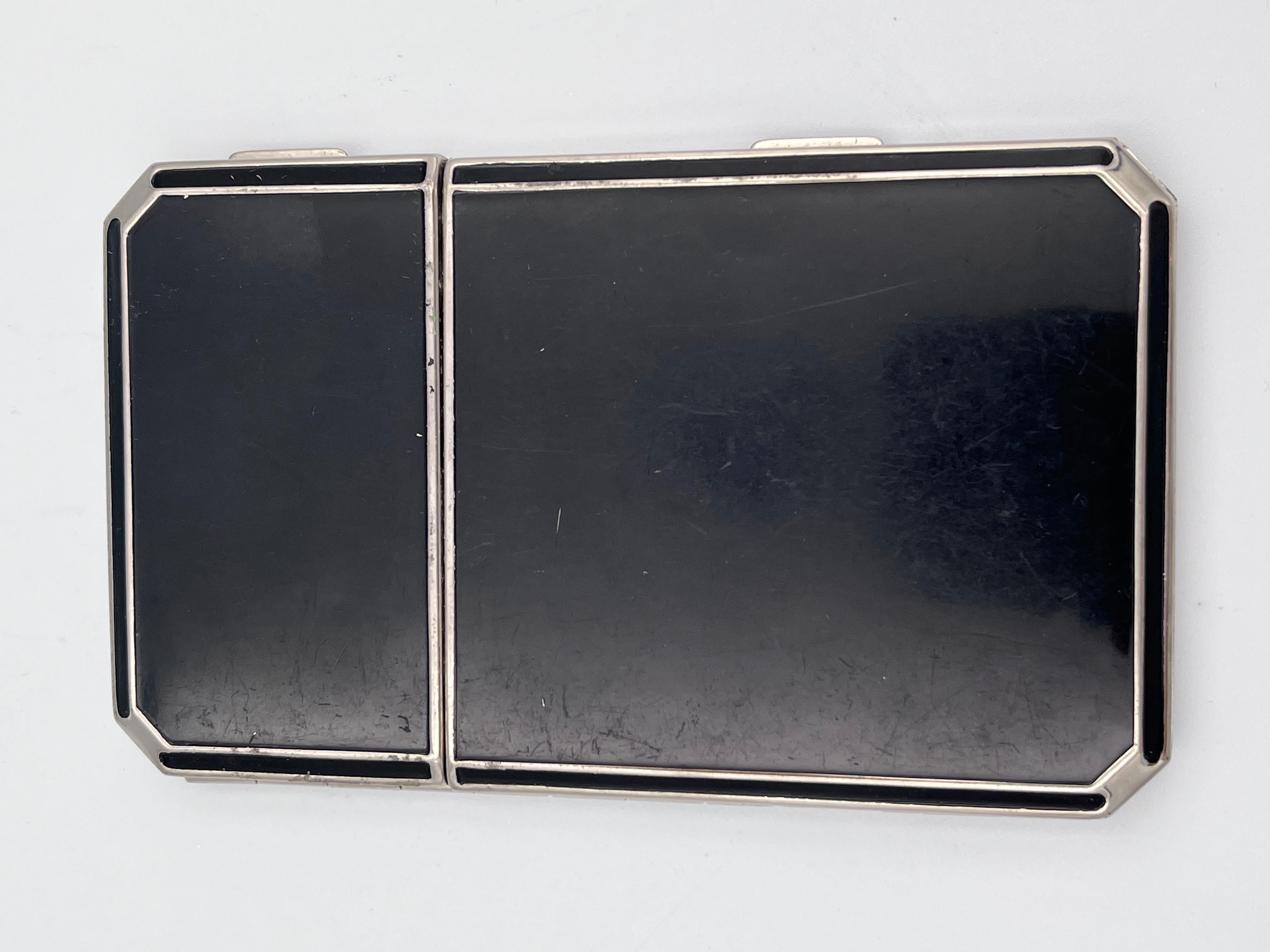 Sleek Art Deco Black Enamel Ladies Cigarette Case and Compact by Richard Hudnut, 1920s

This elegant Art Deco ladies’ cigarette case and compact by Richard Hudnut captures the glamour and sophistication of the Jazz Age. Crafted with sleek black
