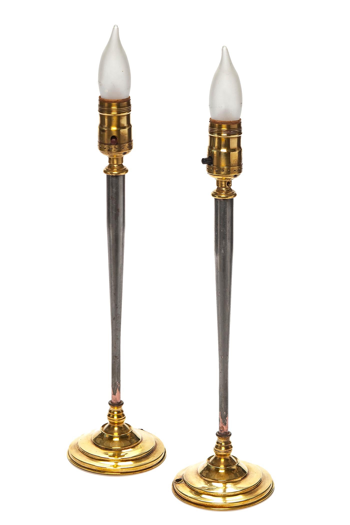 Sleek Candlestick Buffet lamps, with brass bases finished in high polish, offsetting the 