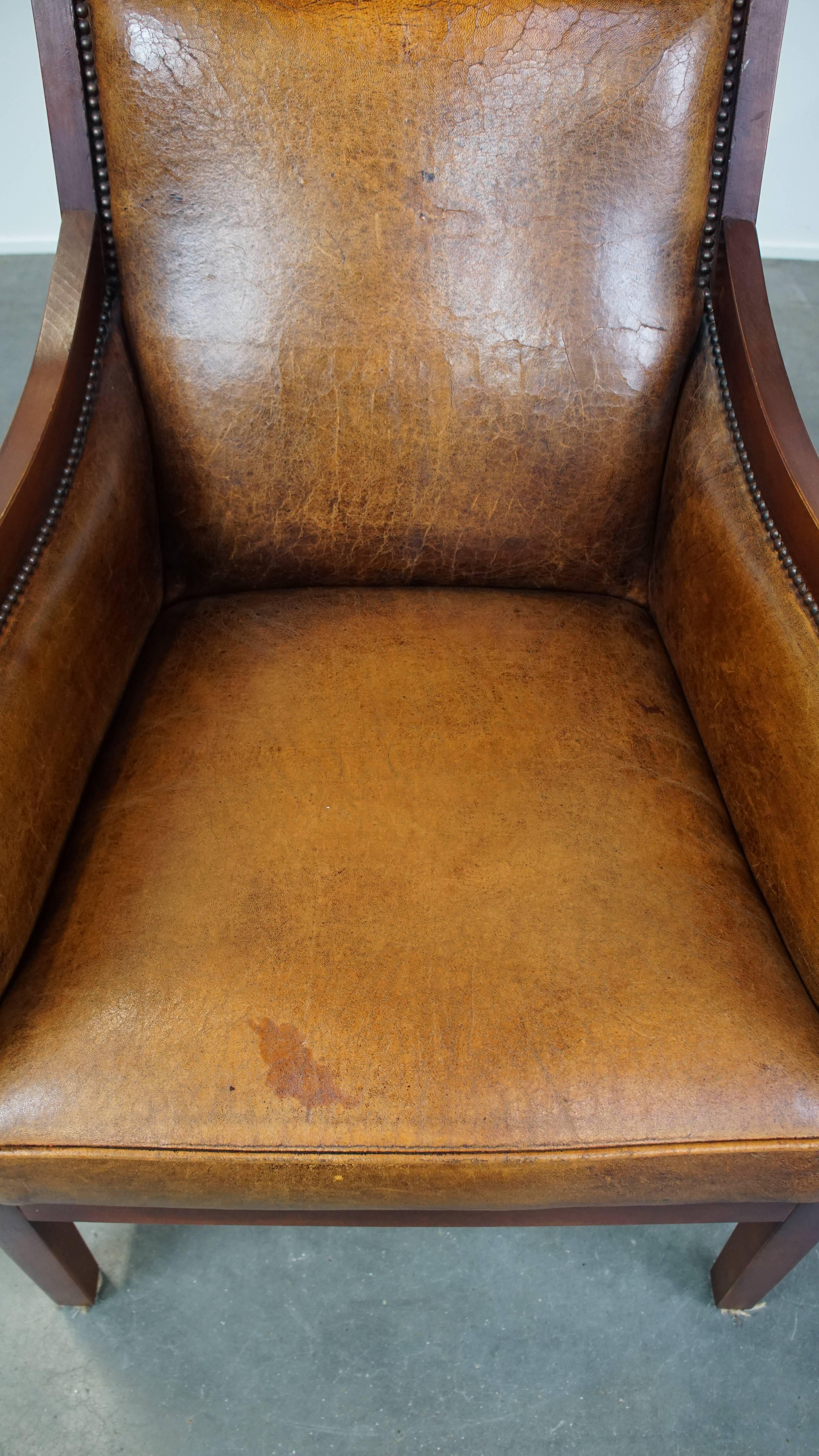 Leather Sleek, beautiful sheepskin leather and wood vintage Art Deco design armchair For Sale