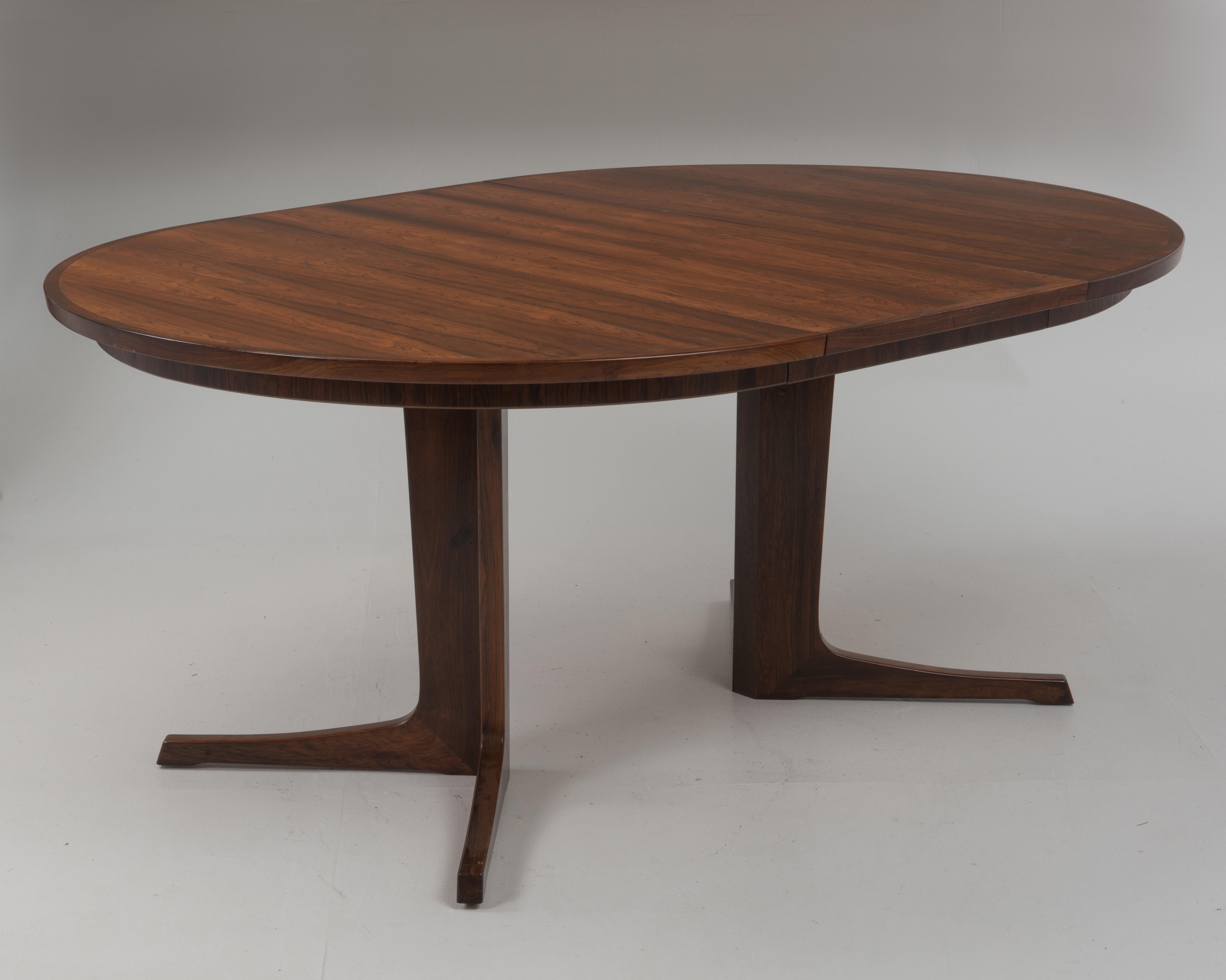 A stunning Bernhard Pedersen & Son rosewood dining table. Book matched rosewood top and two 19.25