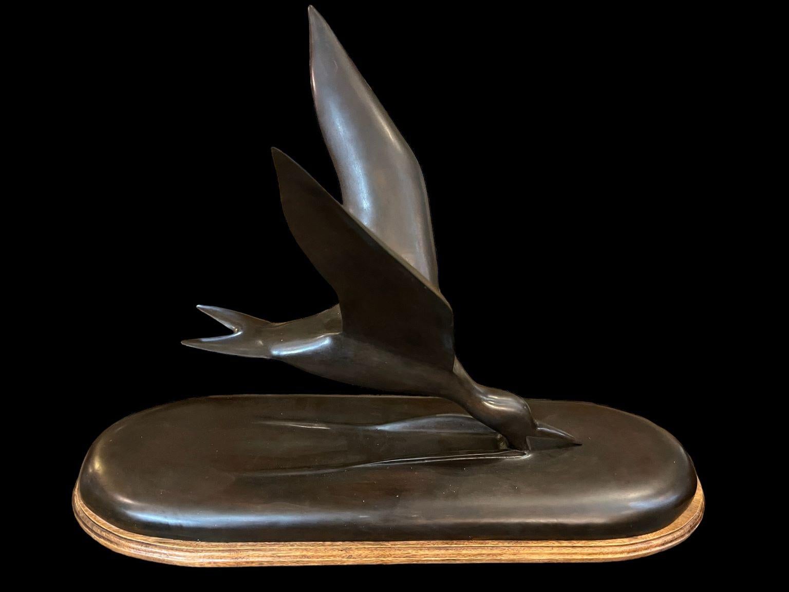 Incredible sleek bronze Seagull Skimmer by P.S. Bowe mounted on a beautiful mahogany base. Bronze is signed and marked on bottom P.S. Bowe circa 1983 3 of 7. Dimensions 30 inches long by 20 inches high and 15.75 inches wide. 