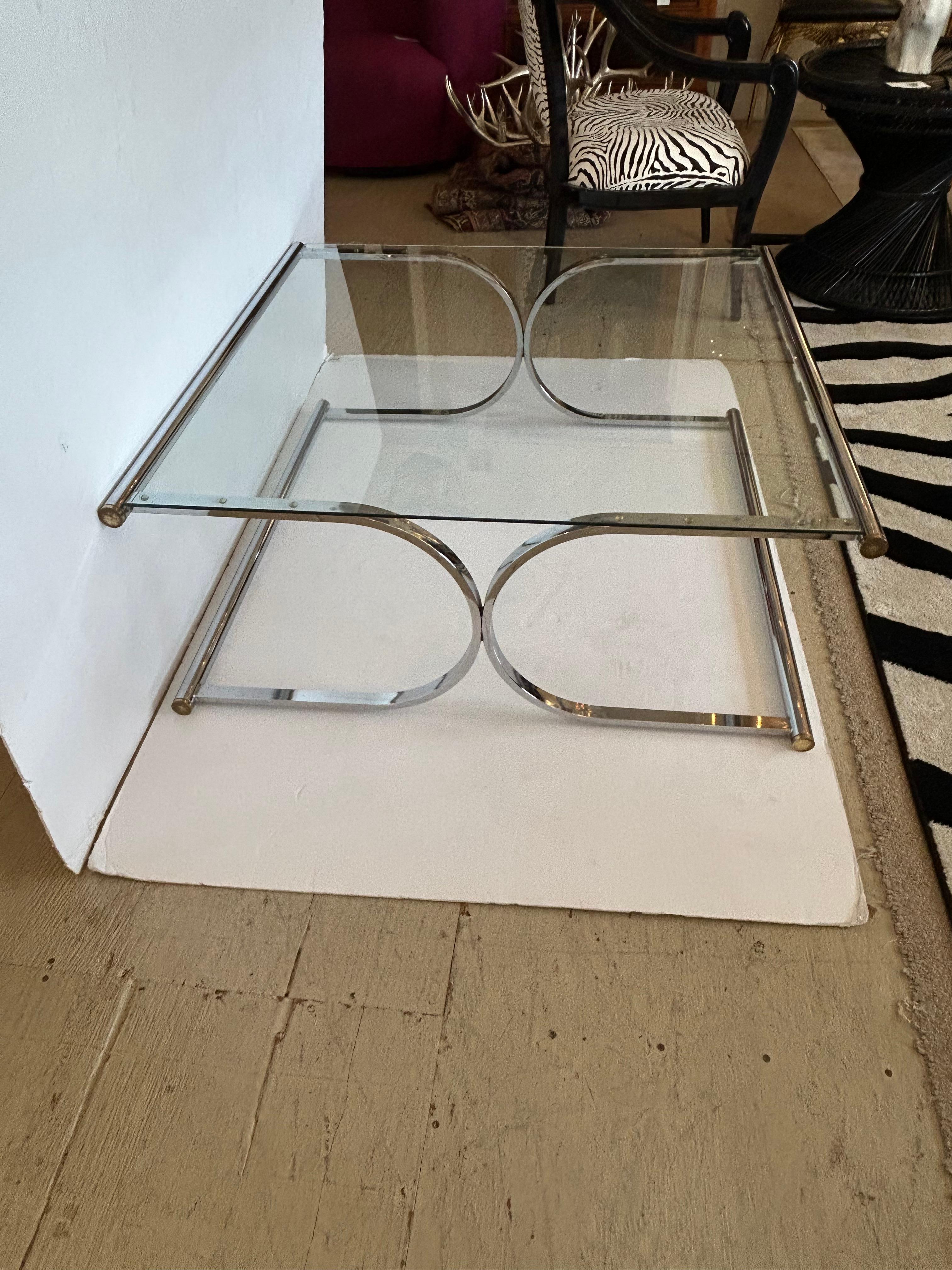 Sofisticato ed elegante tavolino quadrato di grandi dimensioni con base tubolare in cromo e vetro con accenti in ottone CAP.

CD