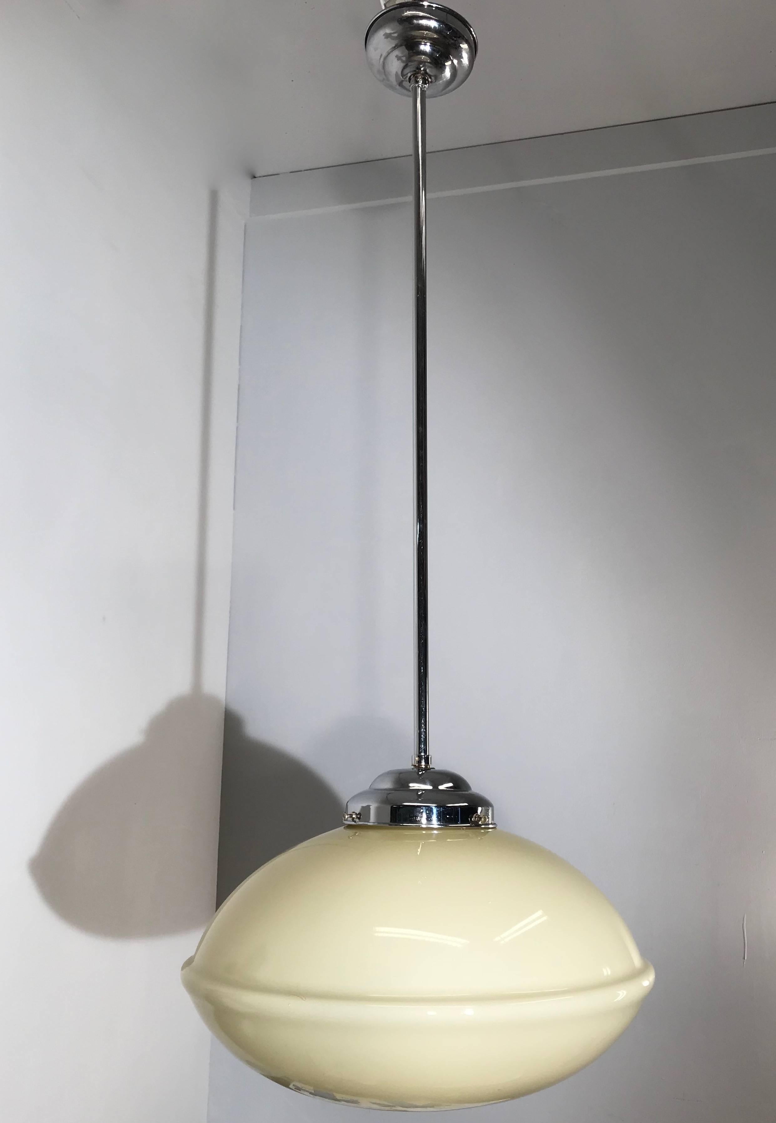 Rare shape, soft yellow Dutch Gispen style pendant.

This good size, 1930s light fixture comes with the original stem, canopy and shade holder. Because of the fantastic design and the better than average materials we attribute this rare light