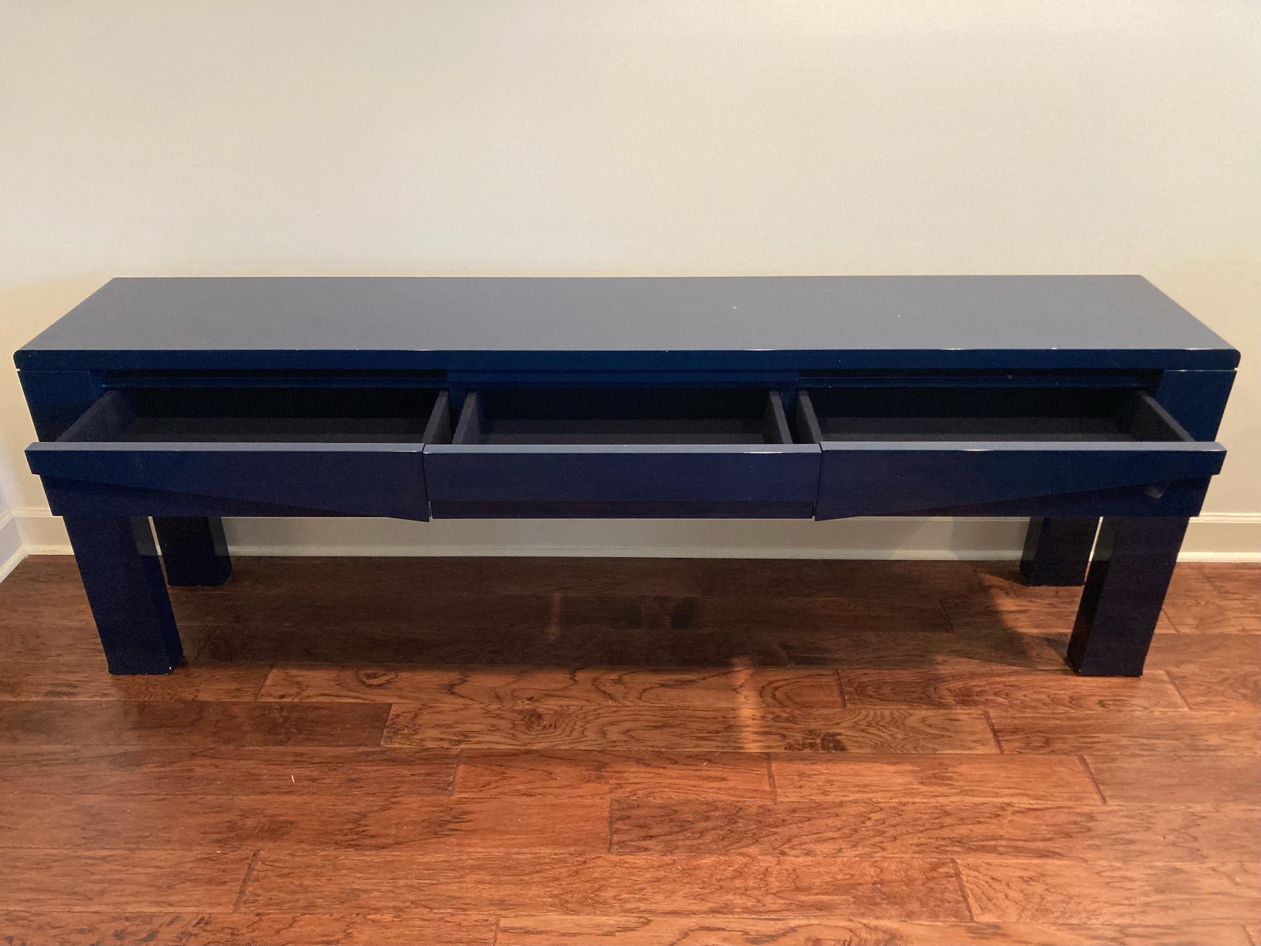 Super sleek sophisticated glistening midnight blue lacquer console by famous Belgian designer Emiel Veranneman by DeCoene Decor. There are 3 drawers on the front side.
