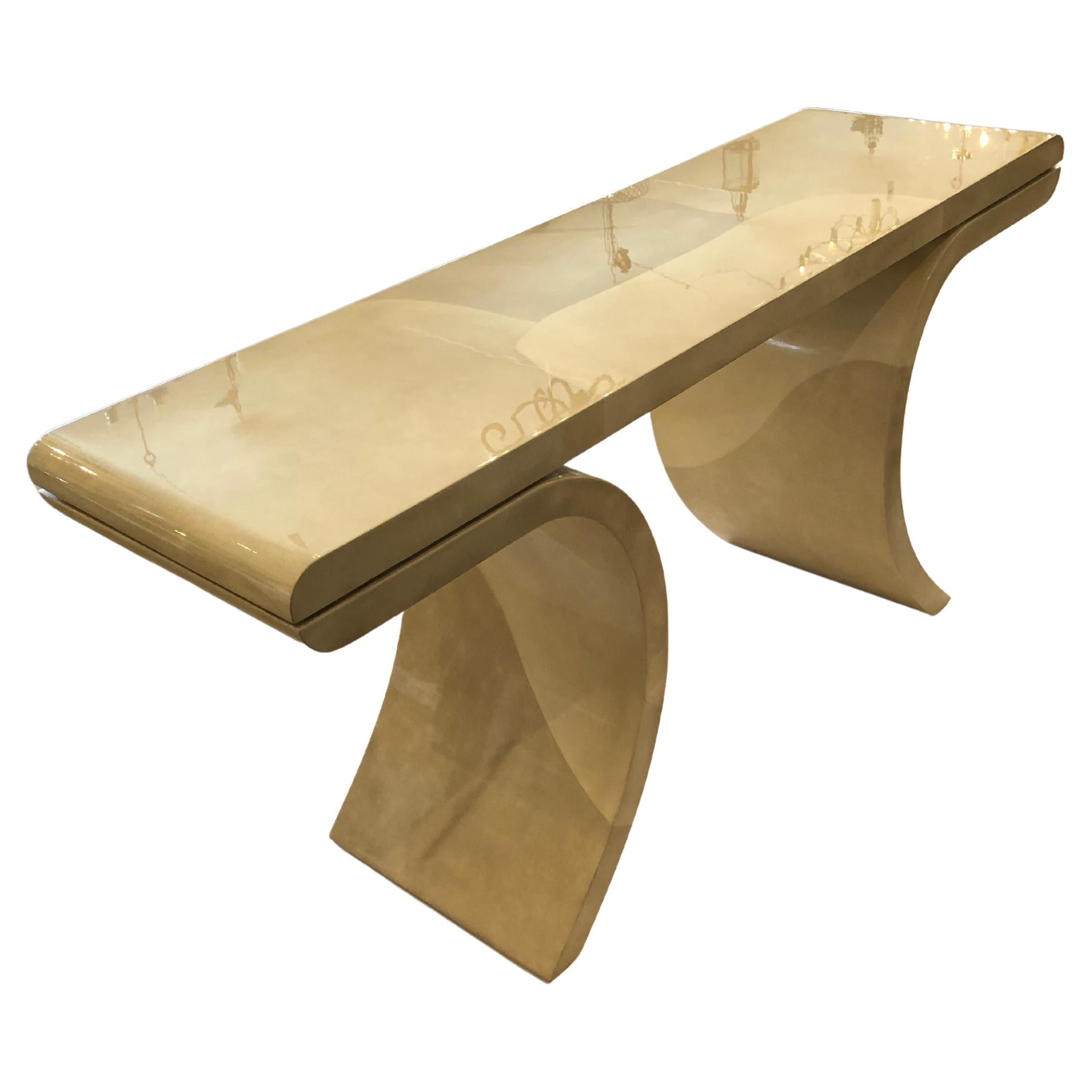 Super chic glossy laquered faux goatskin console table in the manner of Karl Springer having shades of beige and fabulous sleek silhouette.  Heavy and well constructed.