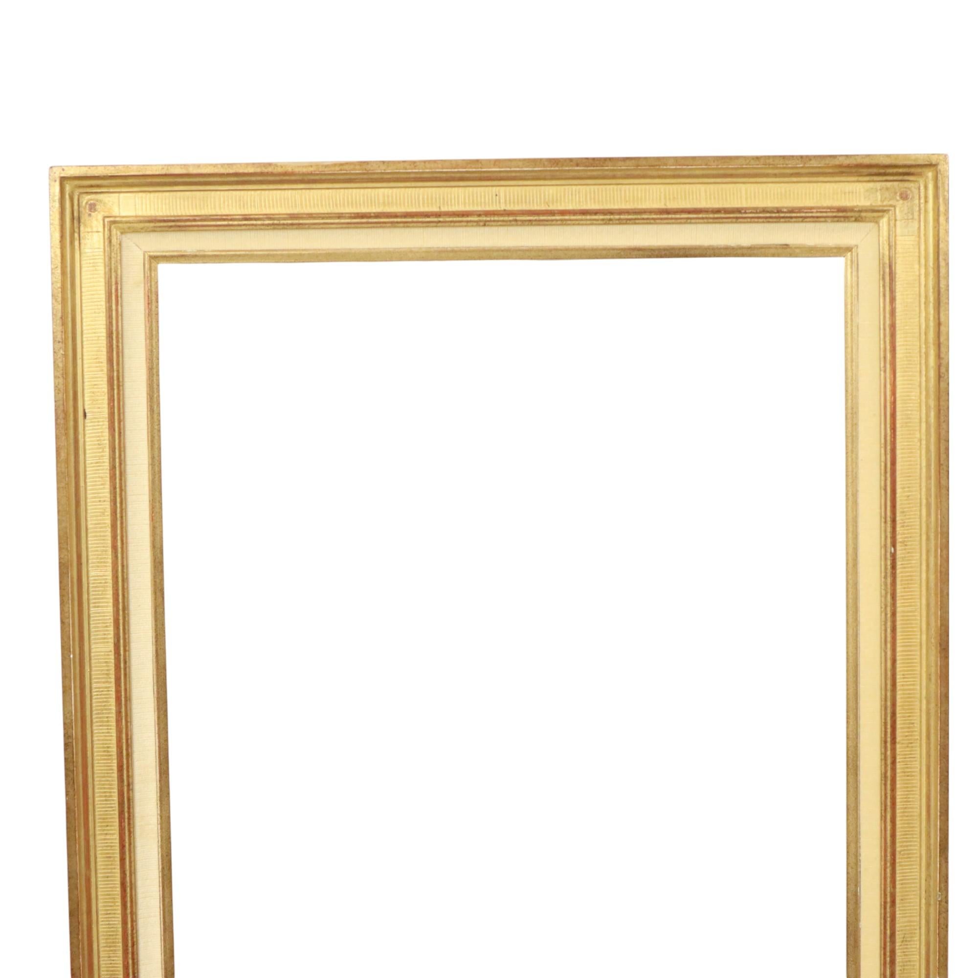 A sleek, vintage gold-colored frame made of solid wood and plaster, entirely in a classic style, decorated with a striped pattern all around, from the second half of the 20th century.

This frame is understated and elegant, not at all extravagant,