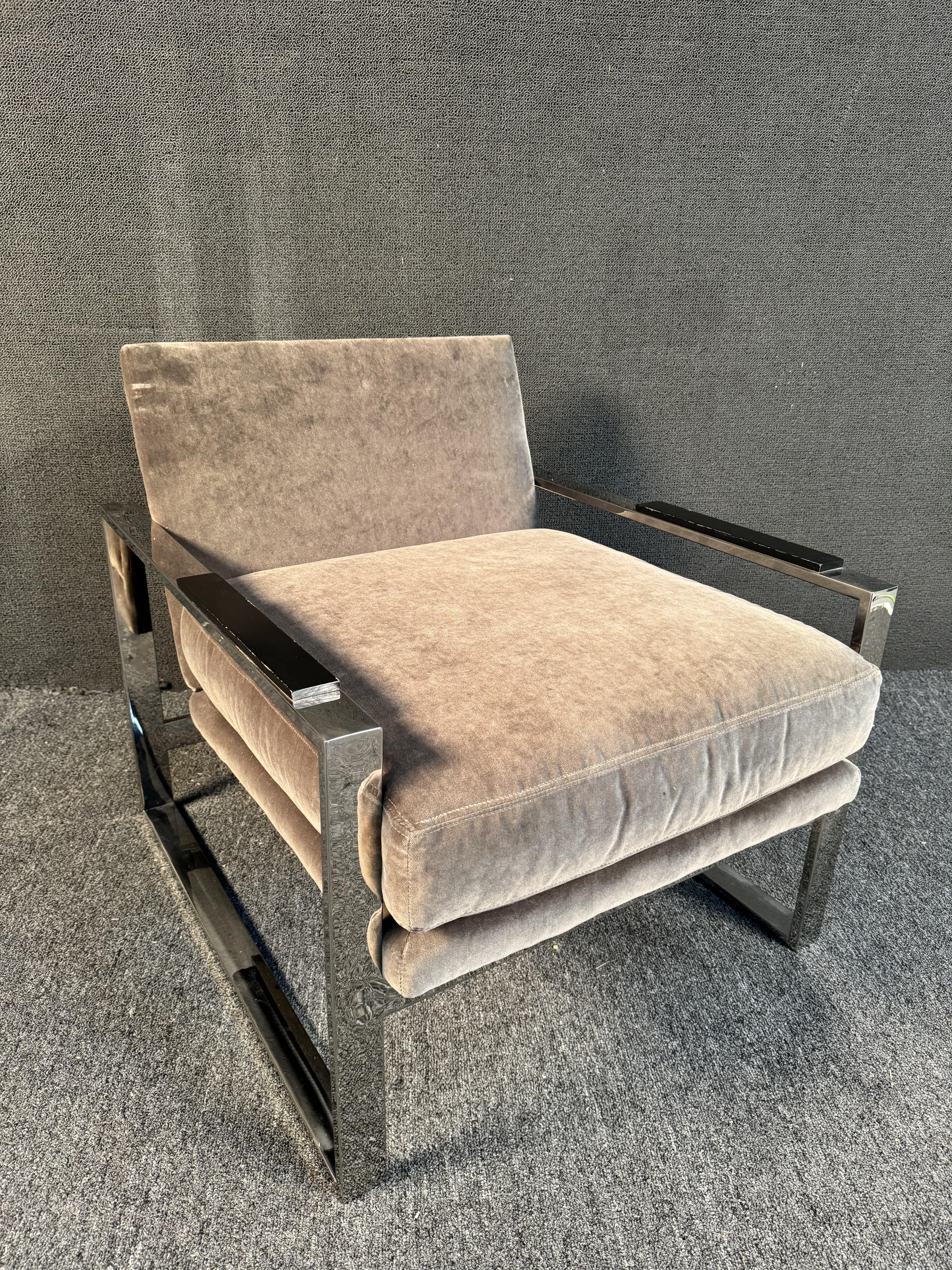 Sleek chrome lounge chair by Michael Weiss featuring wood arm rests and comfortable grey upholstery. Please confirm location (NY or NJ)