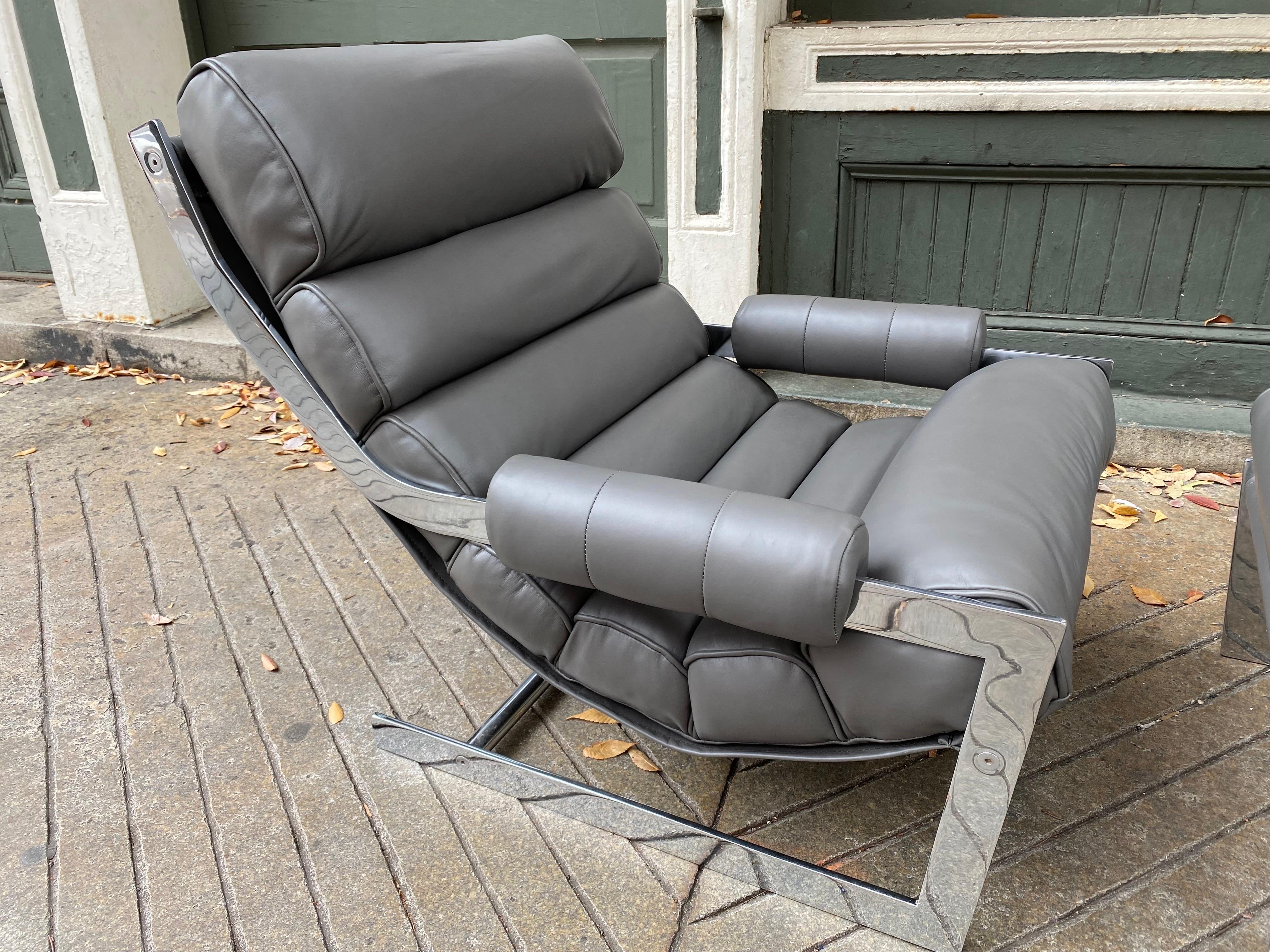 Low Sleek Flat-Band Chrome Lounge Chair and Ottoman.  Newly re-done in a dark gray leather.  Chrome is in amazing condition!  Milo Baughman meets Gilbert Rohde!  Have seen this chair listed before but no definitive designer or maker found. 