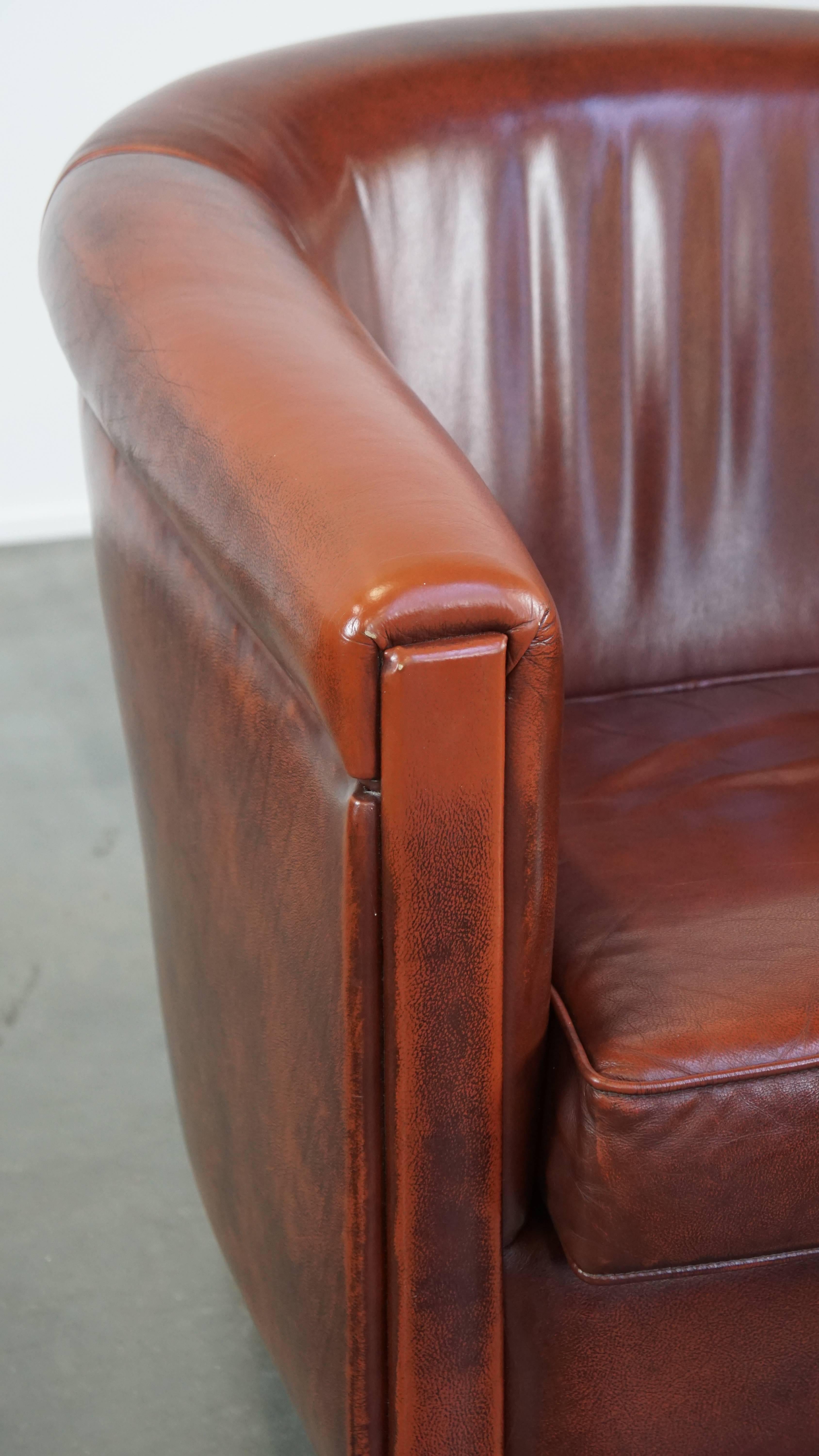 Sleek, luxurious cow leather oxblood red club chair in good condition For Sale 4