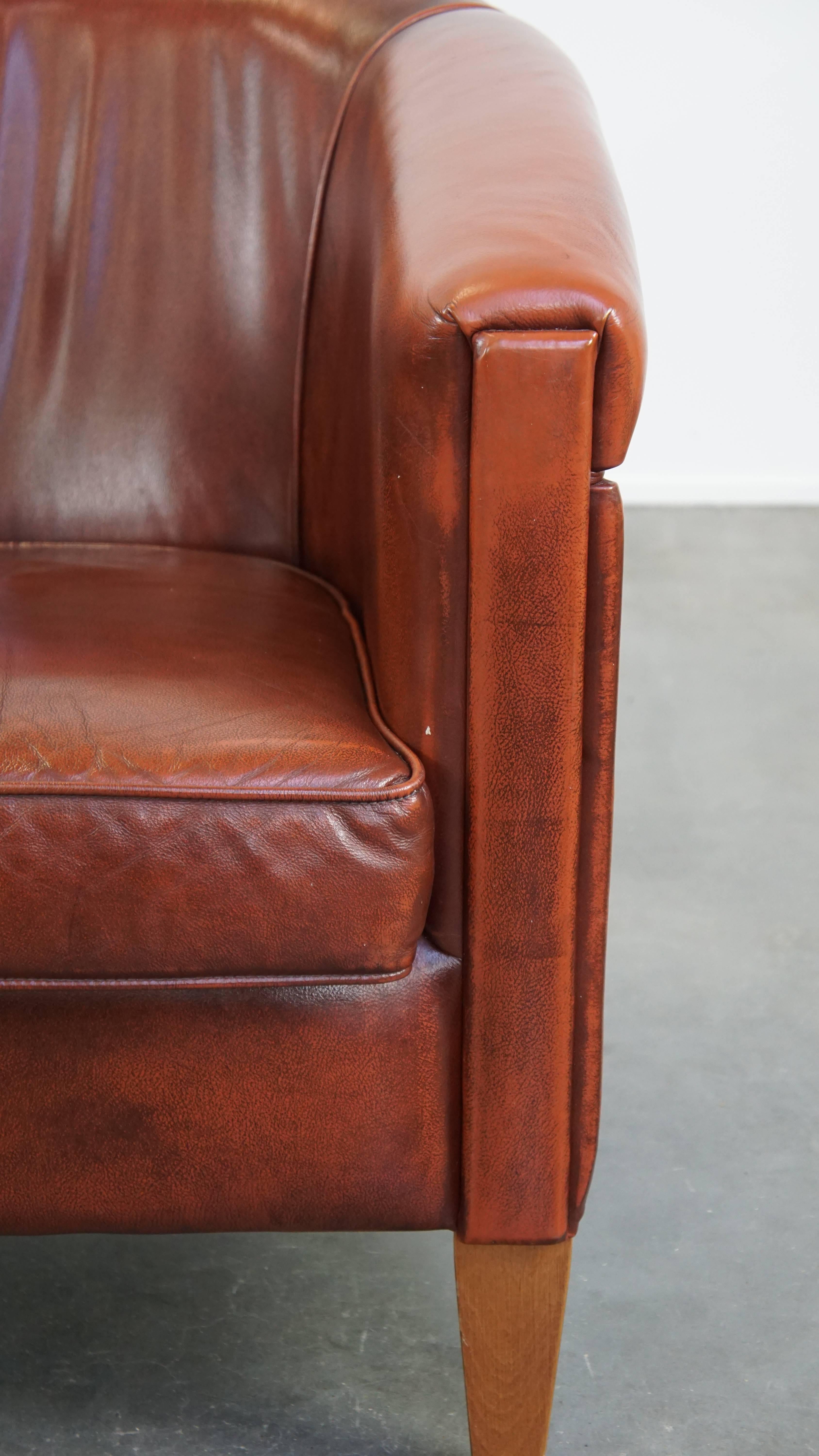 Sleek, luxurious cow leather oxblood red club chair in good condition For Sale 5