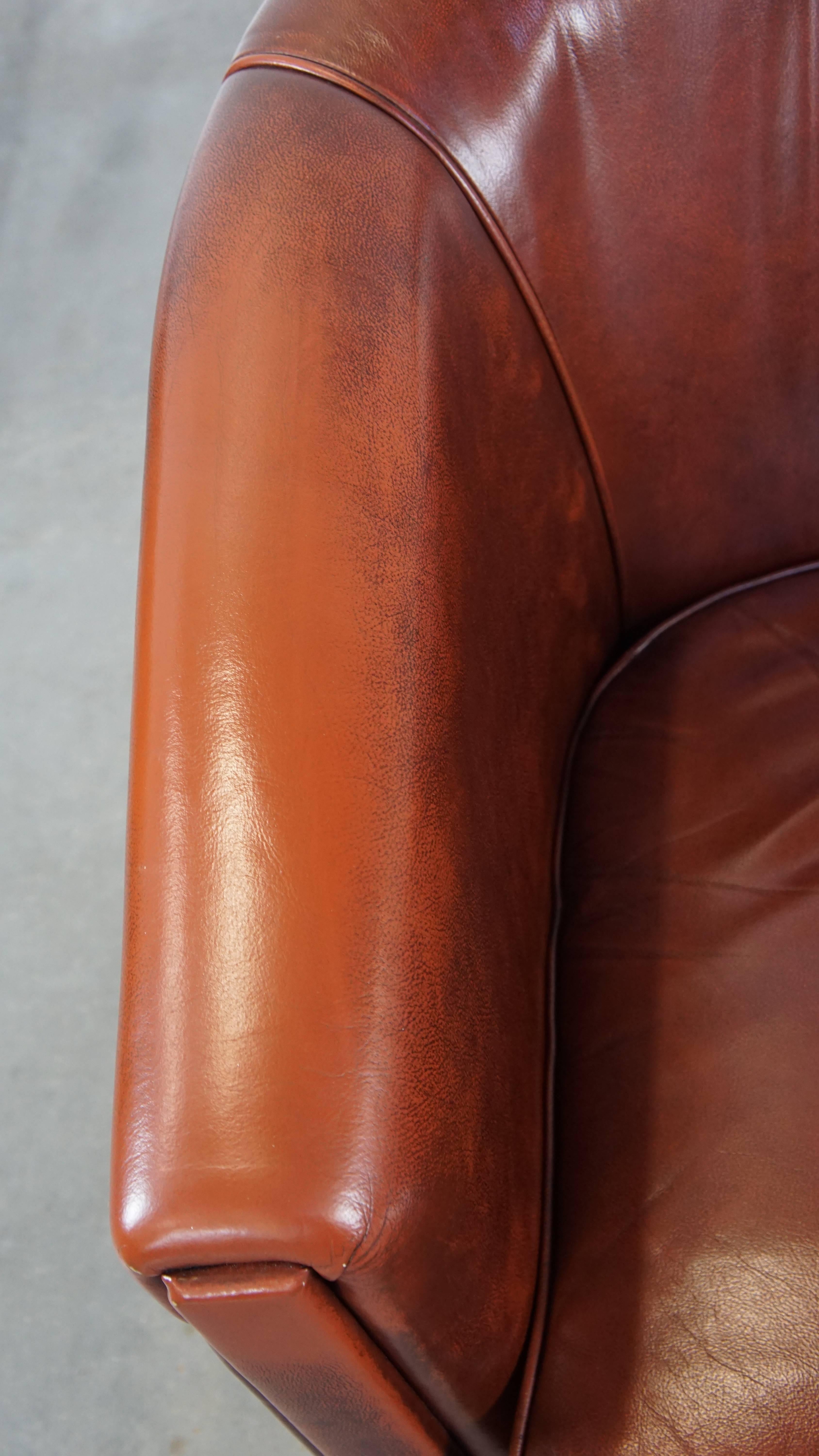 Sleek, luxurious cow leather oxblood red club chair in good condition For Sale 1