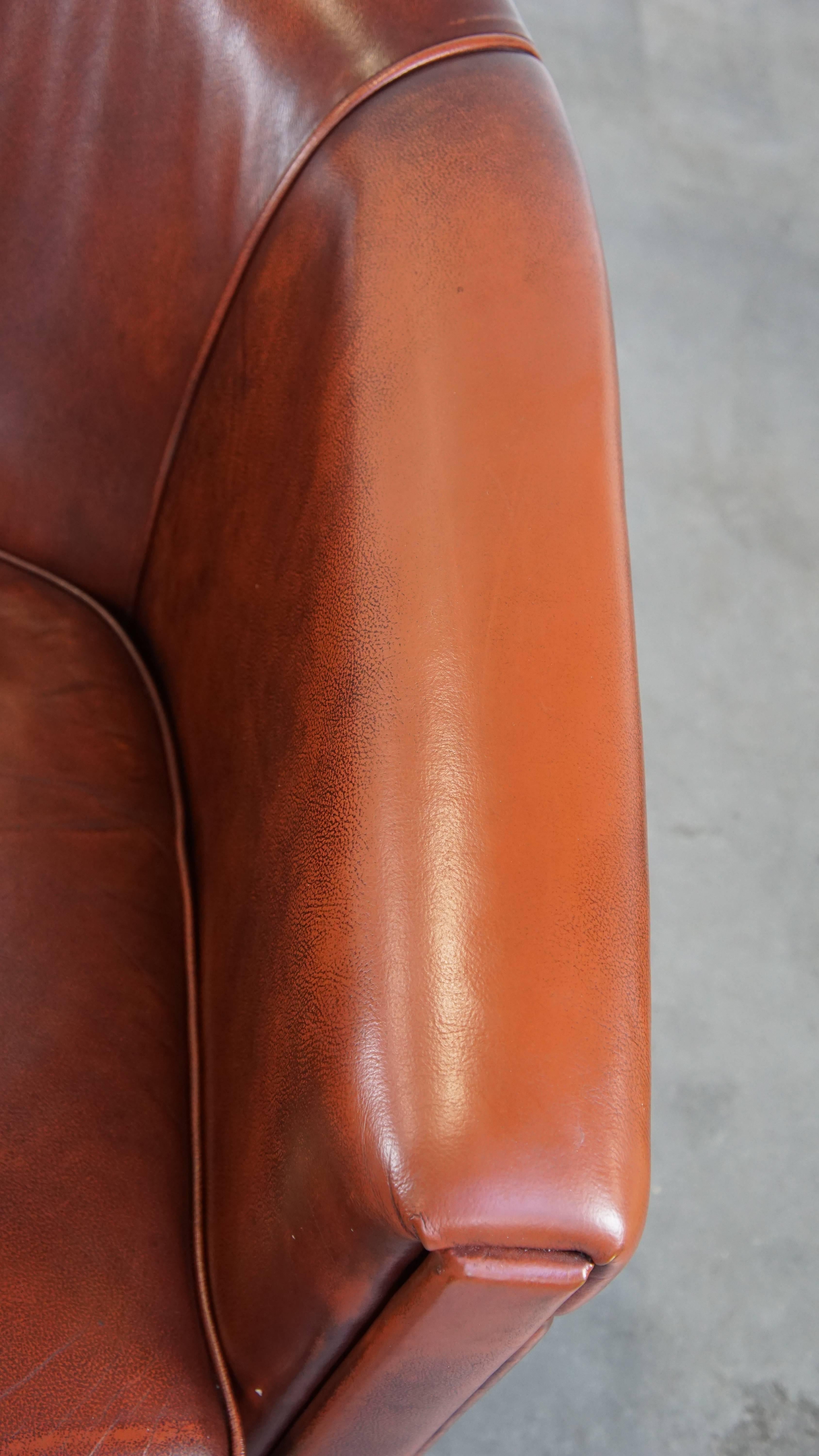 Sleek, luxurious cow leather oxblood red club chair in good condition For Sale 2