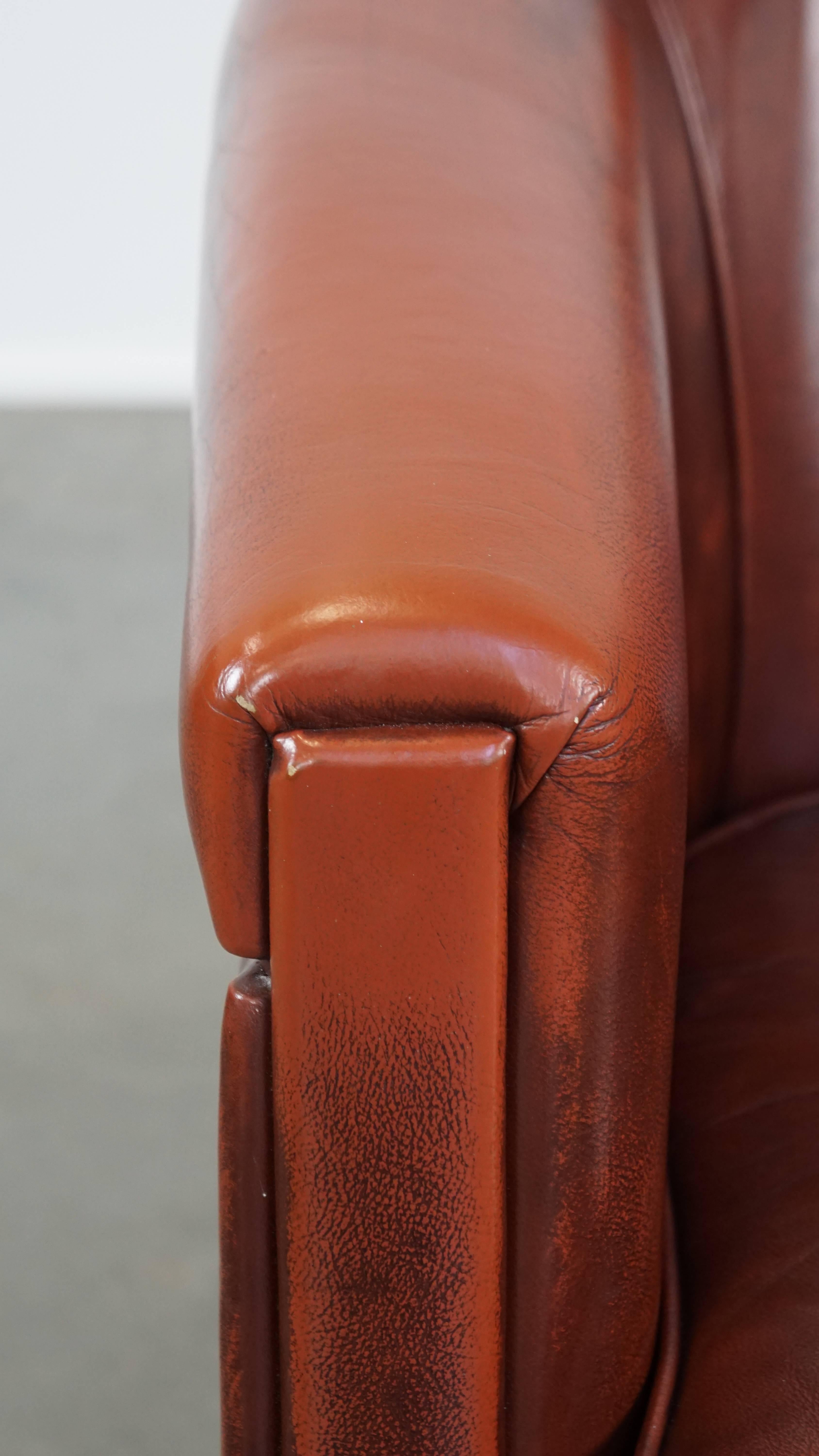 Sleek, luxurious cow leather oxblood red club chair in good condition For Sale 3