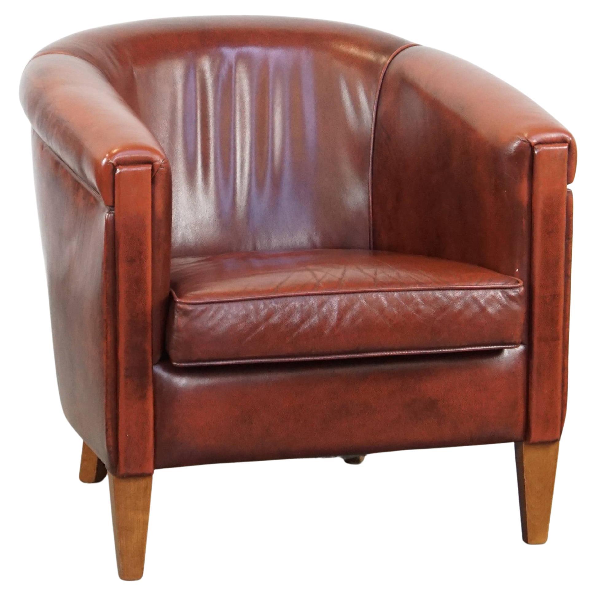 Sleek, luxurious cow leather oxblood red club chair in good condition For Sale