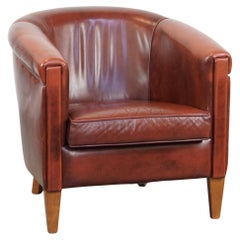 Fauteuil club élégant et luxueux en cuir de vache rouge sang de bœuf en bon état