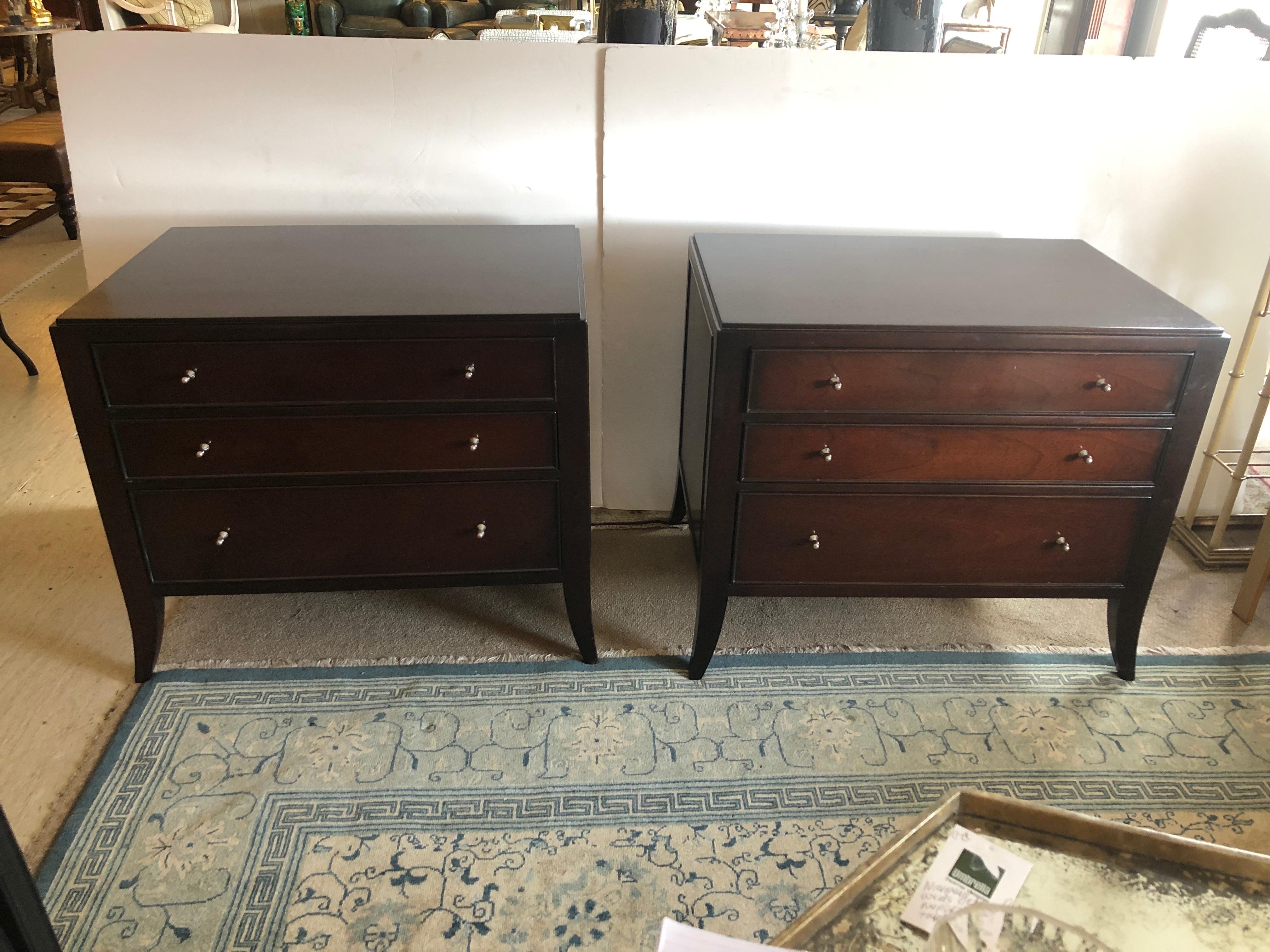 A refined mahogany pair of Baker Furniture nightstands, commodes or end table cabinets designed by Barbara Barry having 3 drawers in each with nickel hardware and elegant slightly splayed legs.