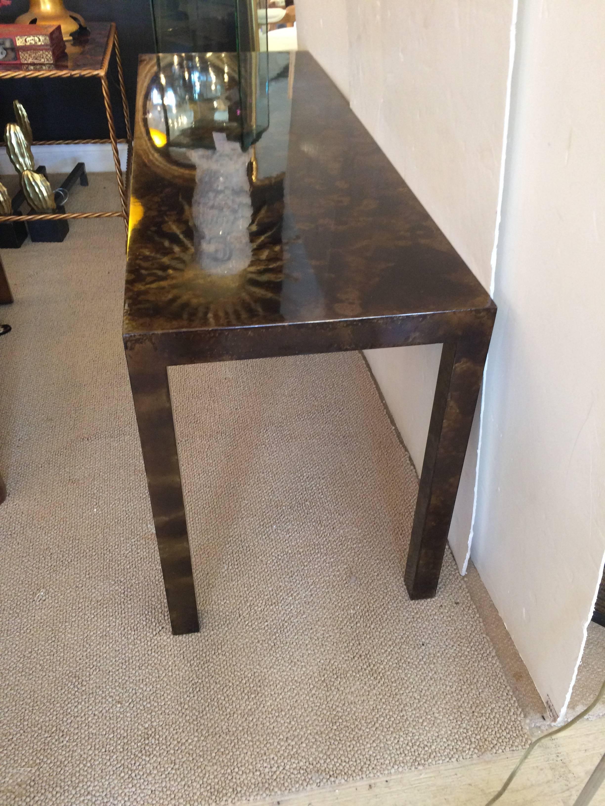 Fabulous midcentury console table in a tortoiseshell veneer over wood. Attributed to John Stuart.