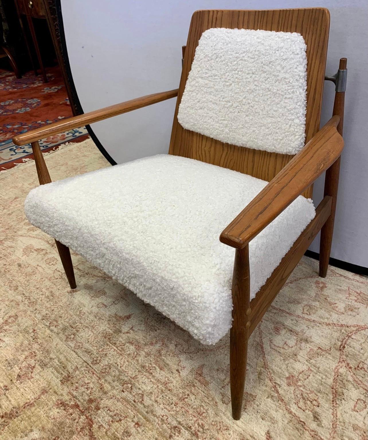 Vintage 1960s Mid-Century Modern teak lounge chair which has been newly reupholstered in boucle fabric which looks like a faux shearling. Sits beautifully and has lines to die for. Featured in Architectural Digest in 2019. Own the best.
