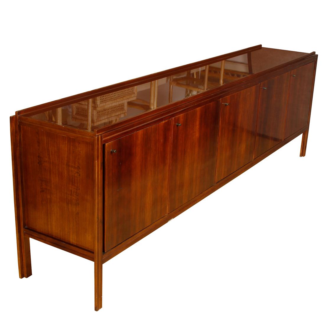 Sleek Mid-Century Modern mahogany sideboard with straight lines and five doors that each reveal a shelf inside.
