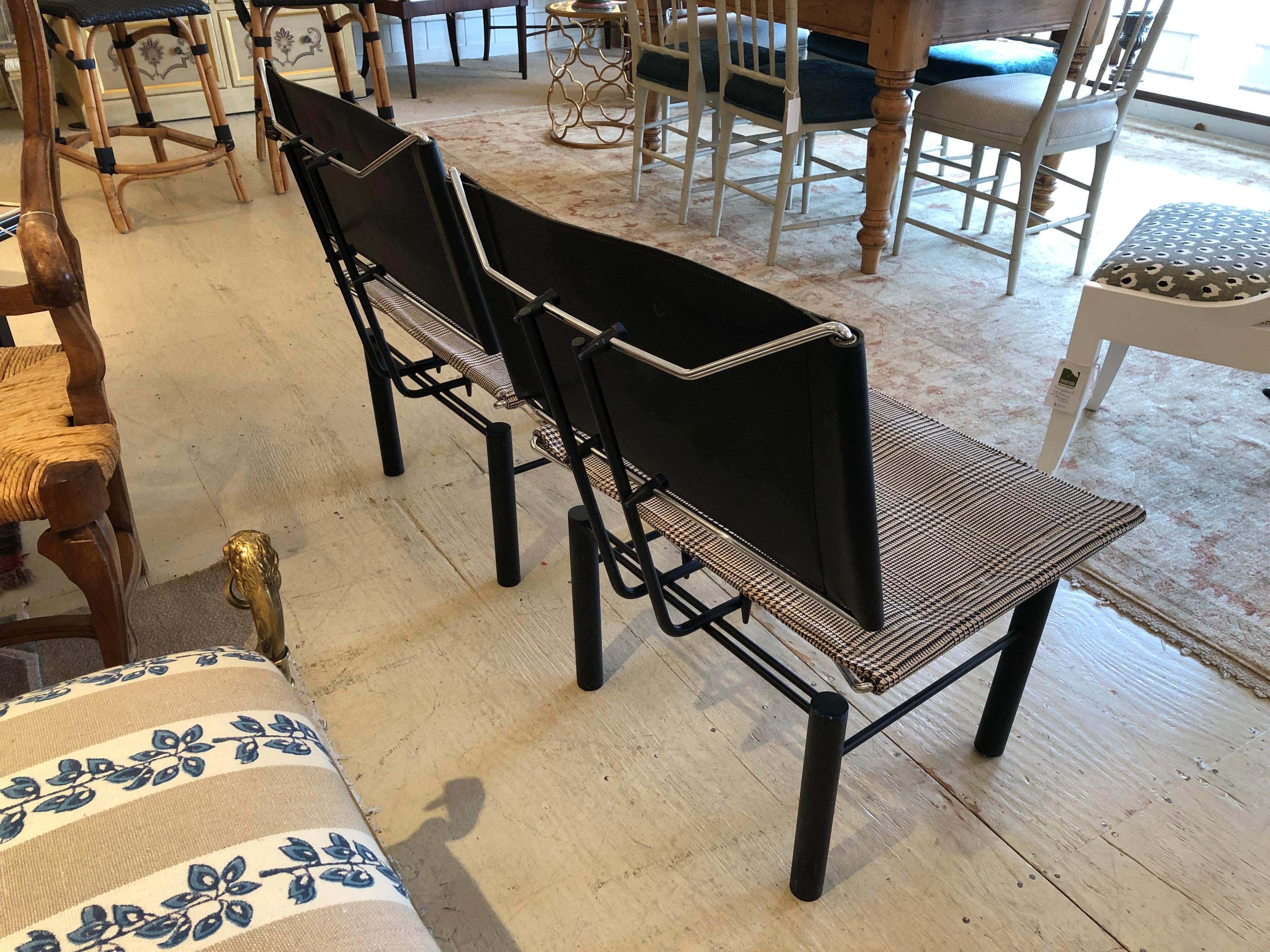 A very unusual super stylish Mid-Century Modern pair of chairs having a space age sleek design mixing chrome, black metal, sling style houndstooth fabric seats and black saddle leather backs. A rare and fascinating find.