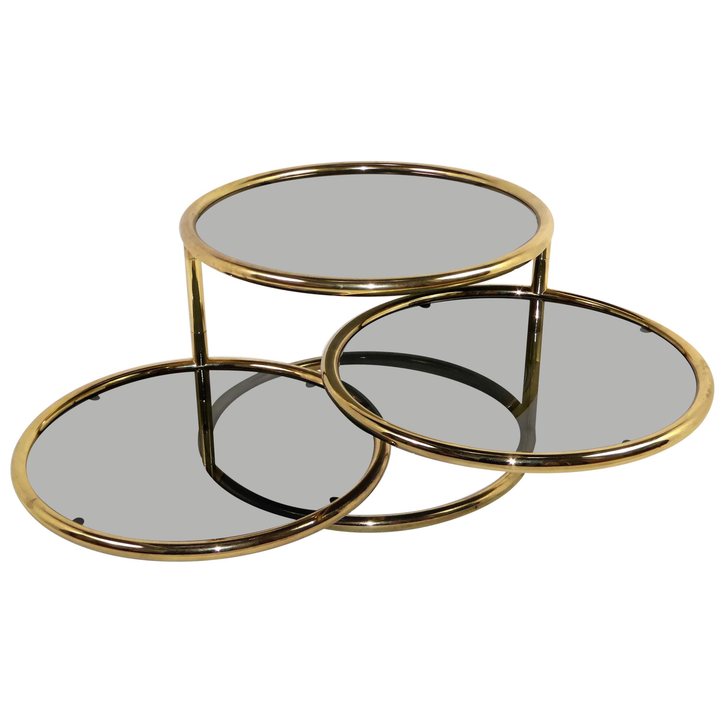 Sleek Milo Baughman Style Brass and Glass Swiveling Coffee Table
