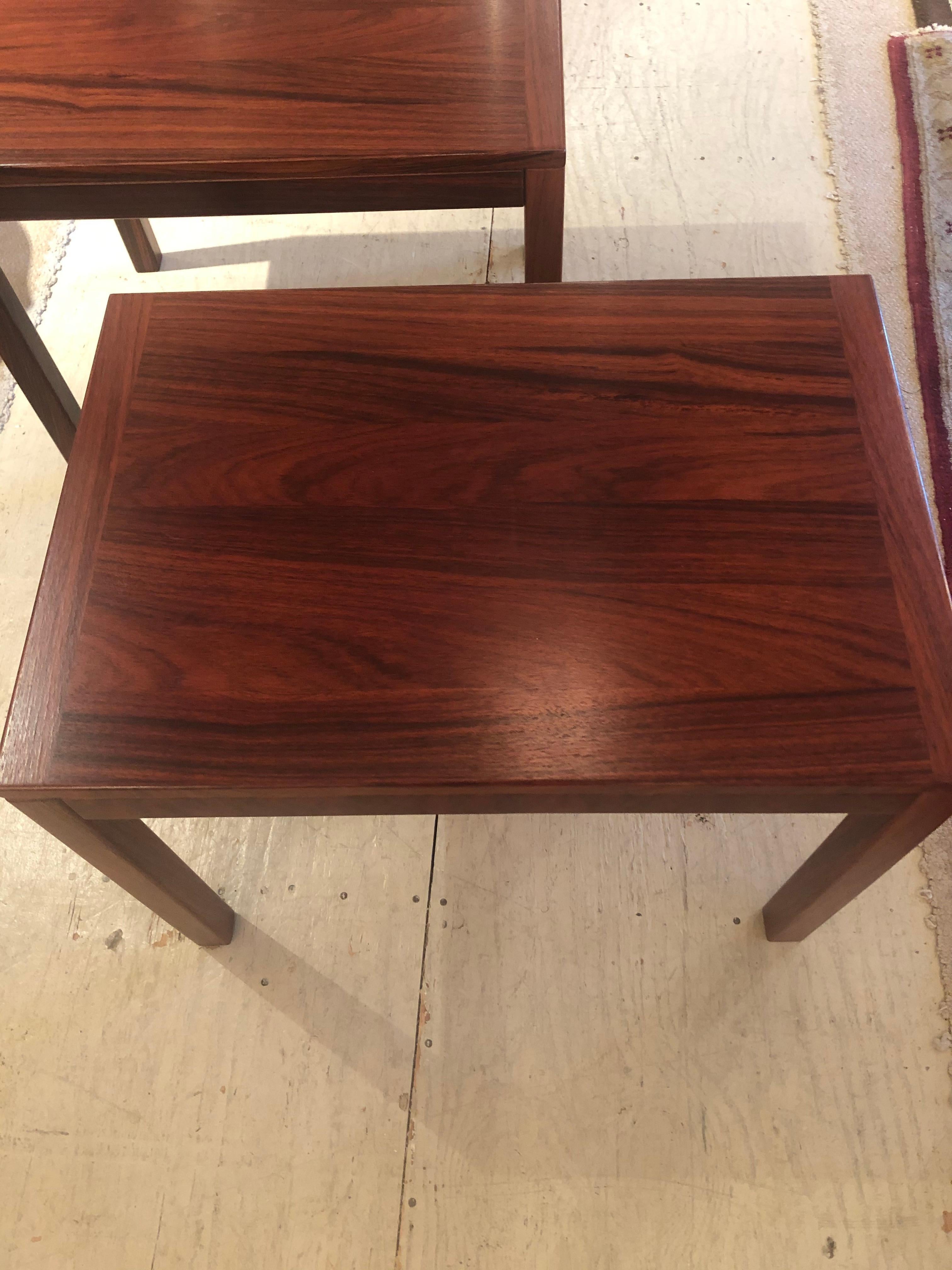 Danish Mid-Century Modern pair of richly stained and beautifully grained sleek rectangular end tables with box edges and elegant simple square legs. Stamped on bottoms.