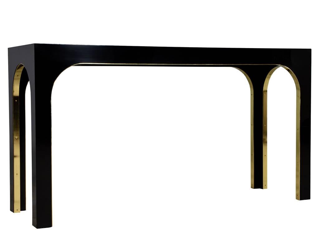 Sleek modern black console with metal accent.
Price includes complimentary curb side delivery to the continental USA.