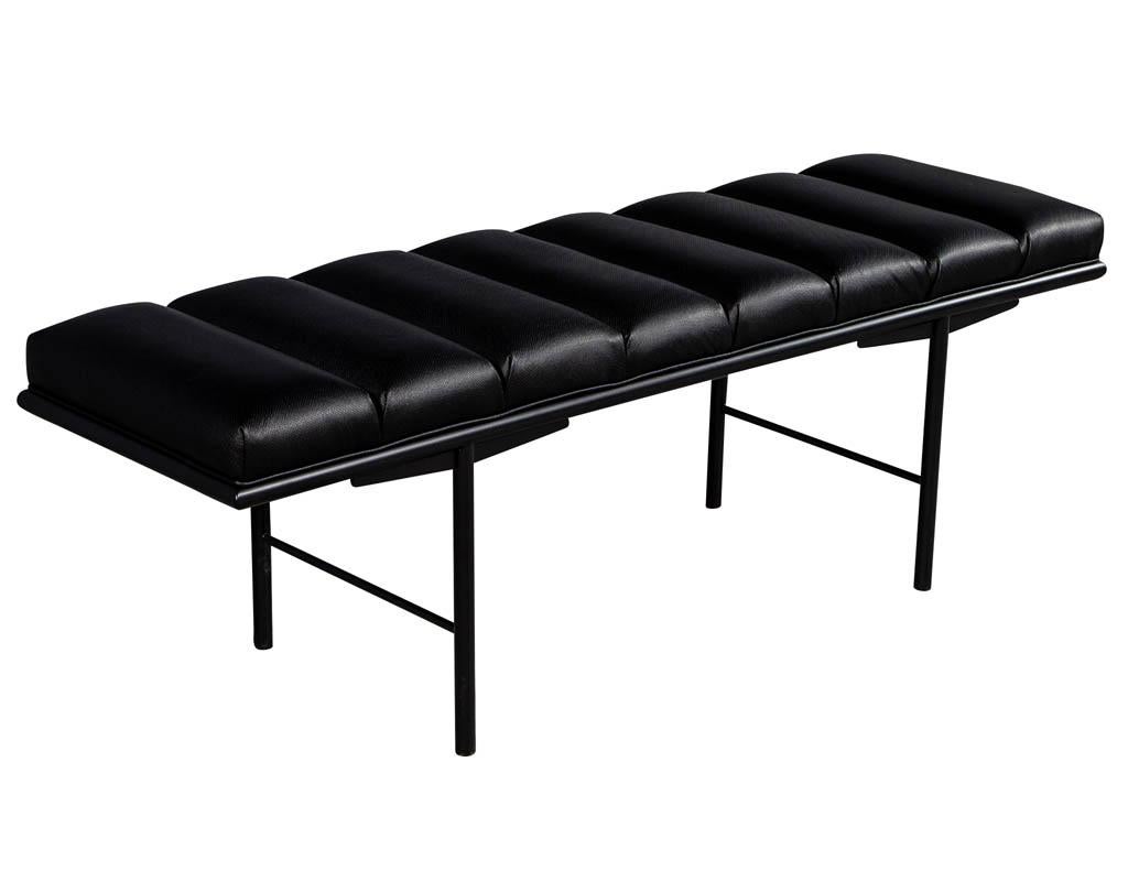Sleek modern black leather accent bench. Clean metal base and perforated leather with a channeled upholstery design.