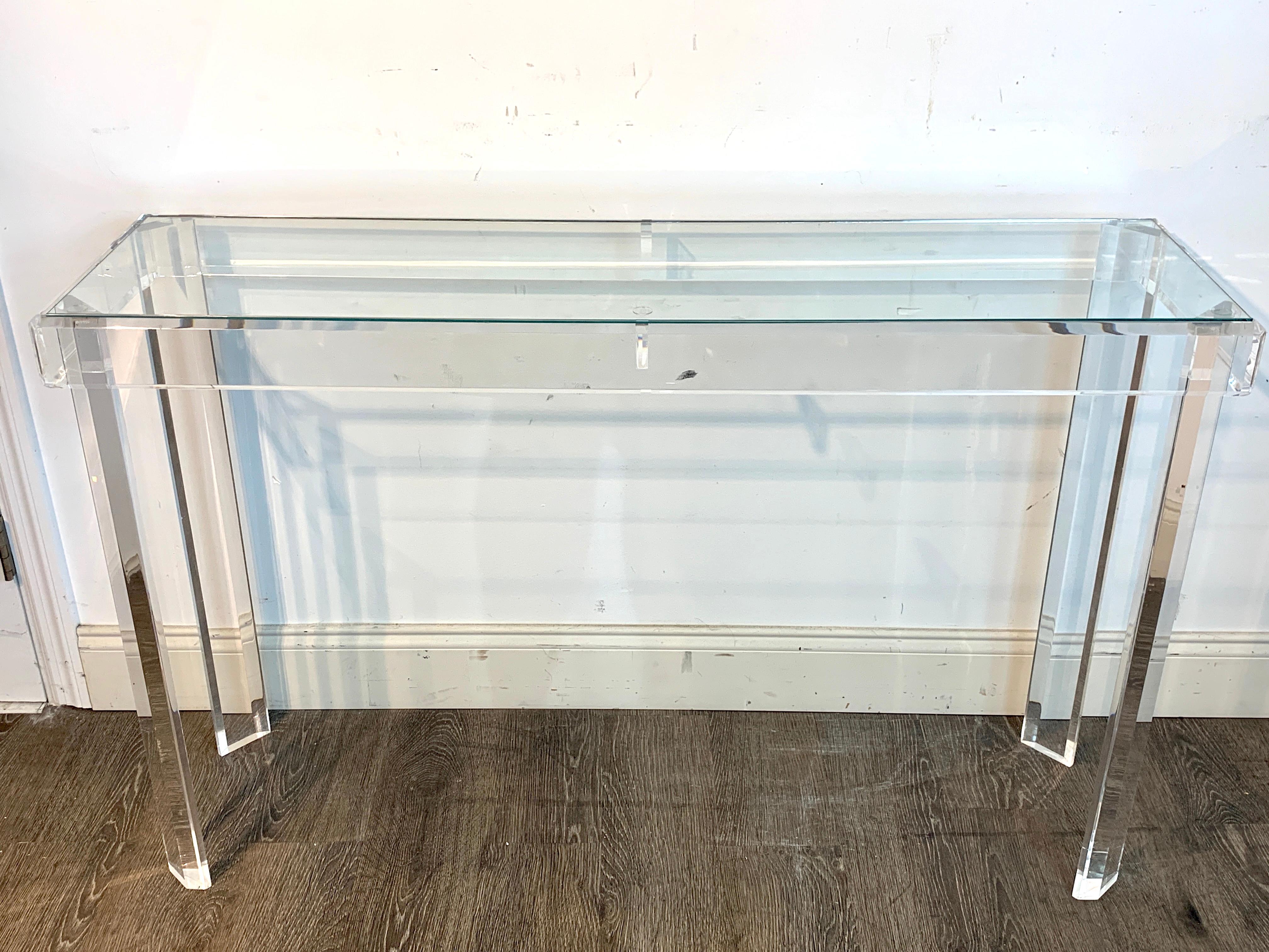 Sleek modern Lucite and glass console, with inset clear glass top, raised on four Marlbourgh legs. This item is located at our West Palm Beach location.