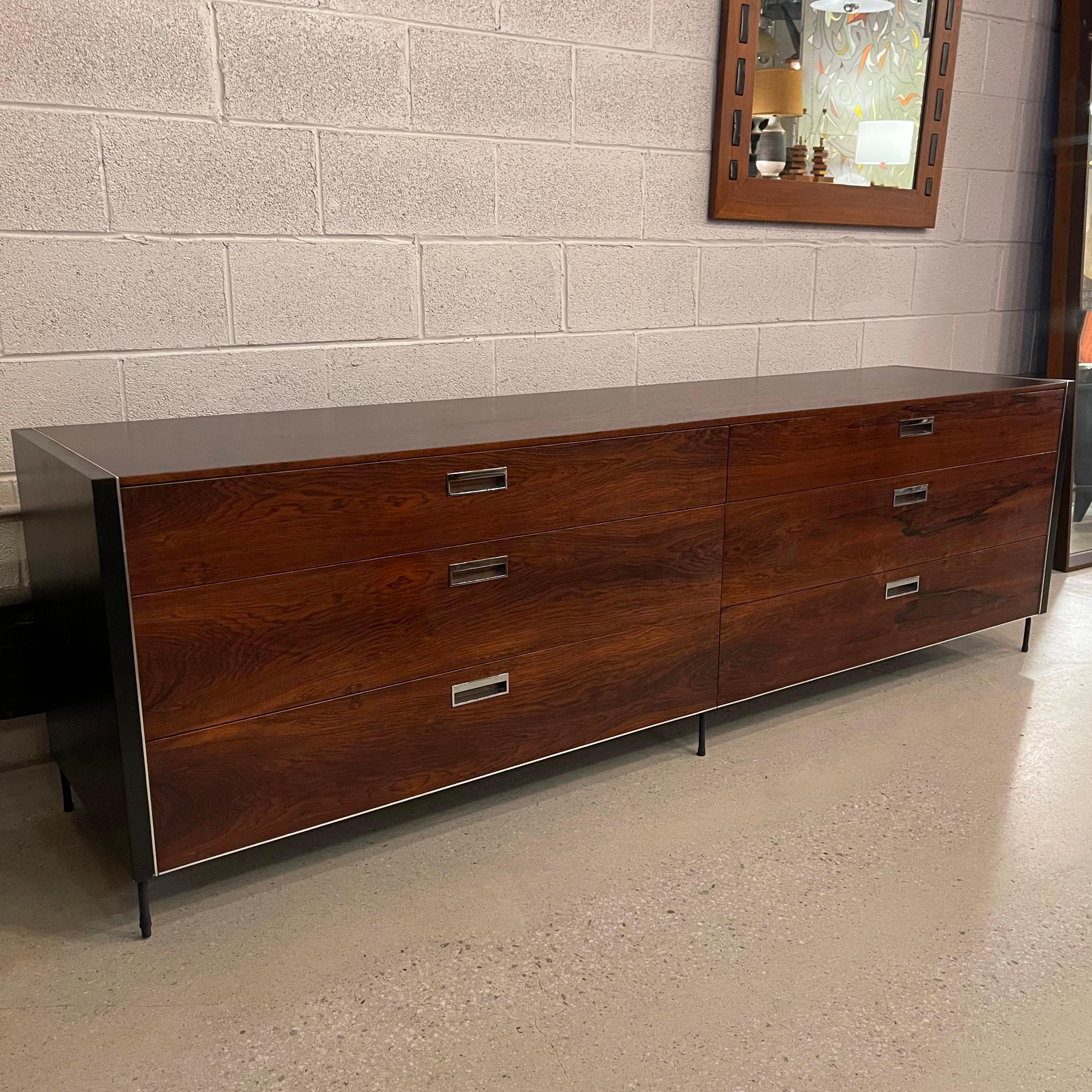 Sleek, modern, low and long, rosewood dresser features contrasting, black laquered sides with chrome trim and chrome recessed pulls on it's six drawers with wrought iron hairpin legs. The dresser has a wonderful, rich rosewood grain throughout.
