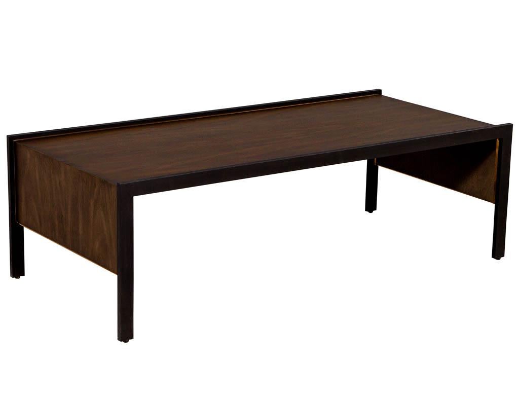 Sleek modern walnut cocktail table by Baker Furniture Milling Road Kara Mann. Sleek modern design, rich walnut in a charcoal stain with oiled bronze metal sides and brass details.

Price includes complimentary curb side delivery to the continental