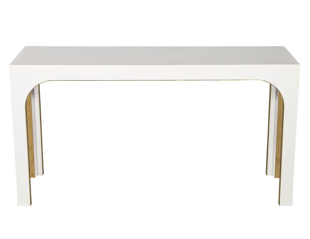 Sleek modern white console table with metal accents.

Price includes complimentary curb side delivery to the continental USA.