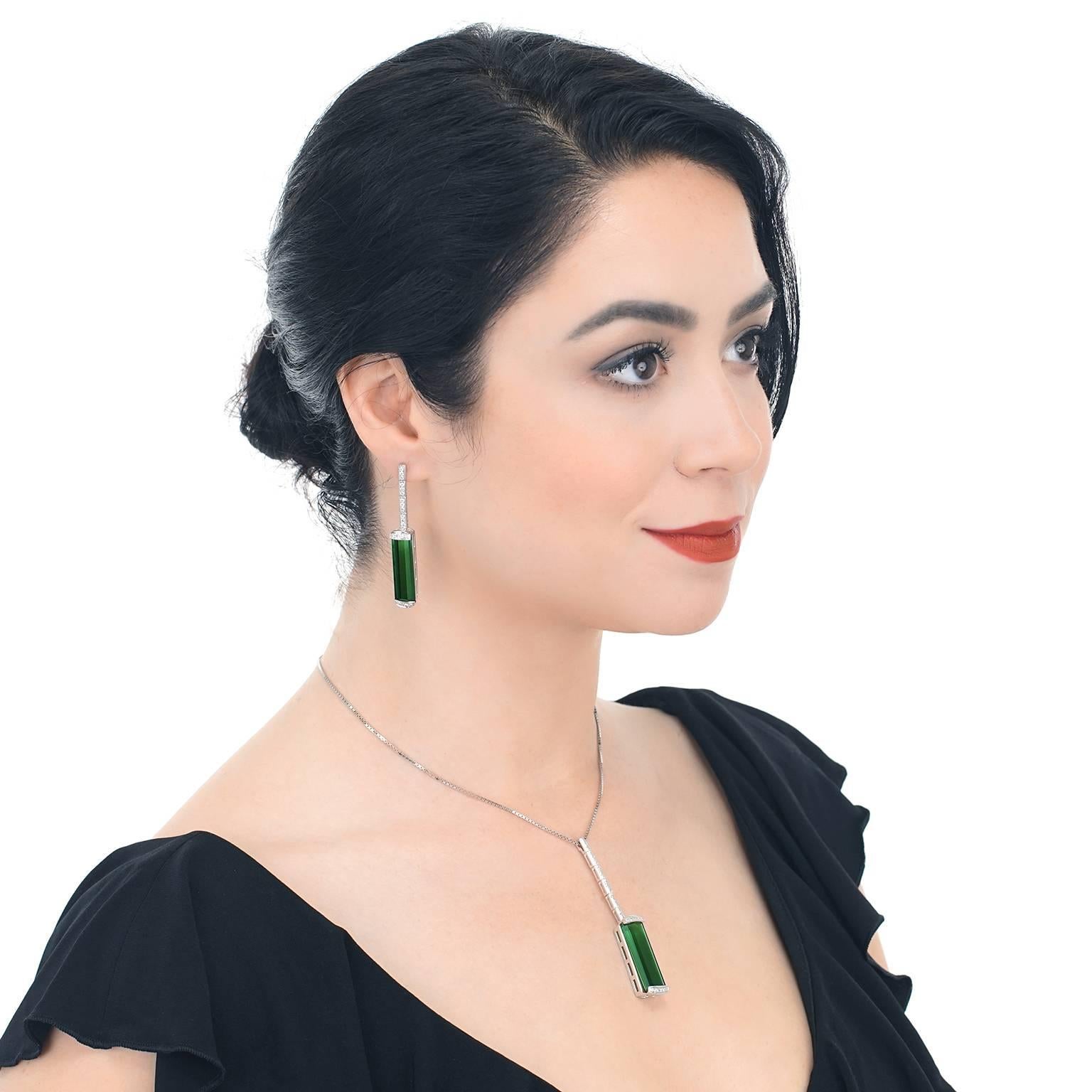 Circa 1980s, 18k.  A vivid column of liquid green pours from a fall of brilliant white diamonds in these quintessentially modern earrings. Underscoring the elegant minimalist design with lush color and white flashes is 29.0 carats of superb