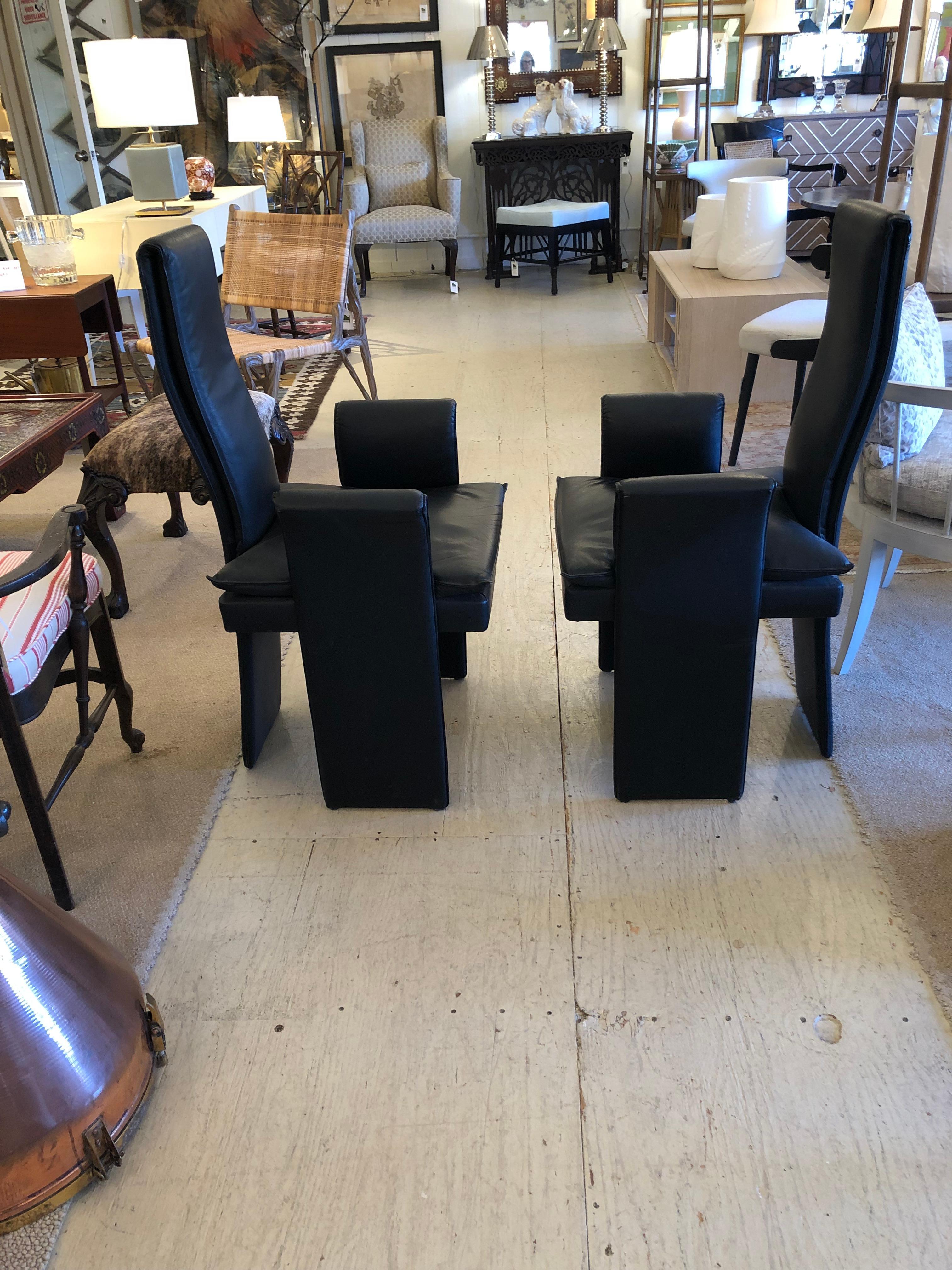 Superbly sculptural Italian Mid-Century Modern armchairs having tall elongated narrow backs that continue downward as the back legs of each chair. The arms jut out and the designer forms make a statement.
