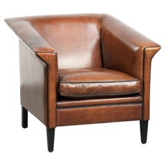 Sleek sheepskin Art Deco design armchair with black piping