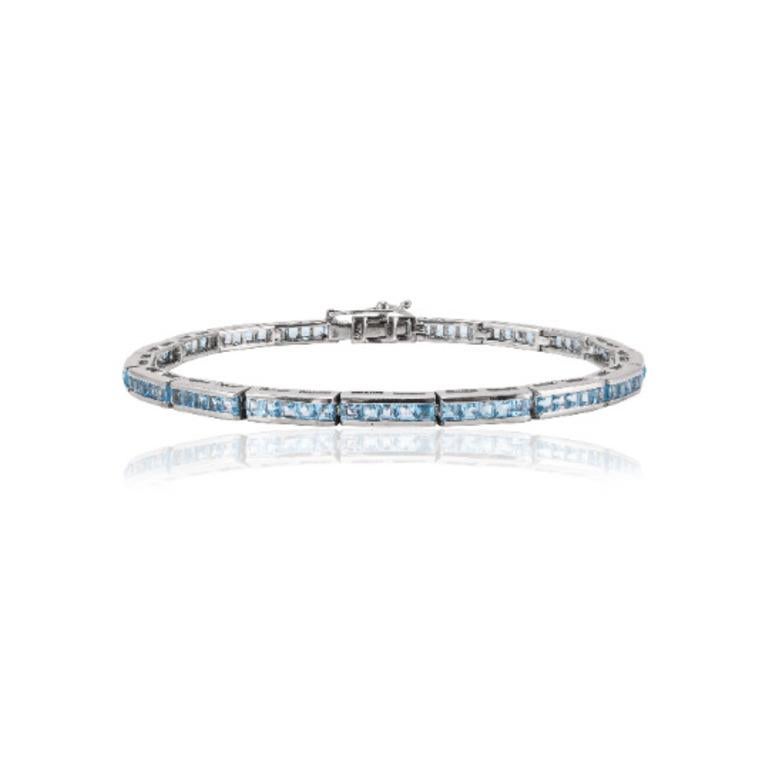 Beautifully handcrafted Sleek Blue Topaz Tennis Bracelet, designed with love, including handpicked luxury gemstones for each designer piece. Grab the spotlight with this exquisitely crafted piece. Inlaid with natural blue topaz gemstones, this
