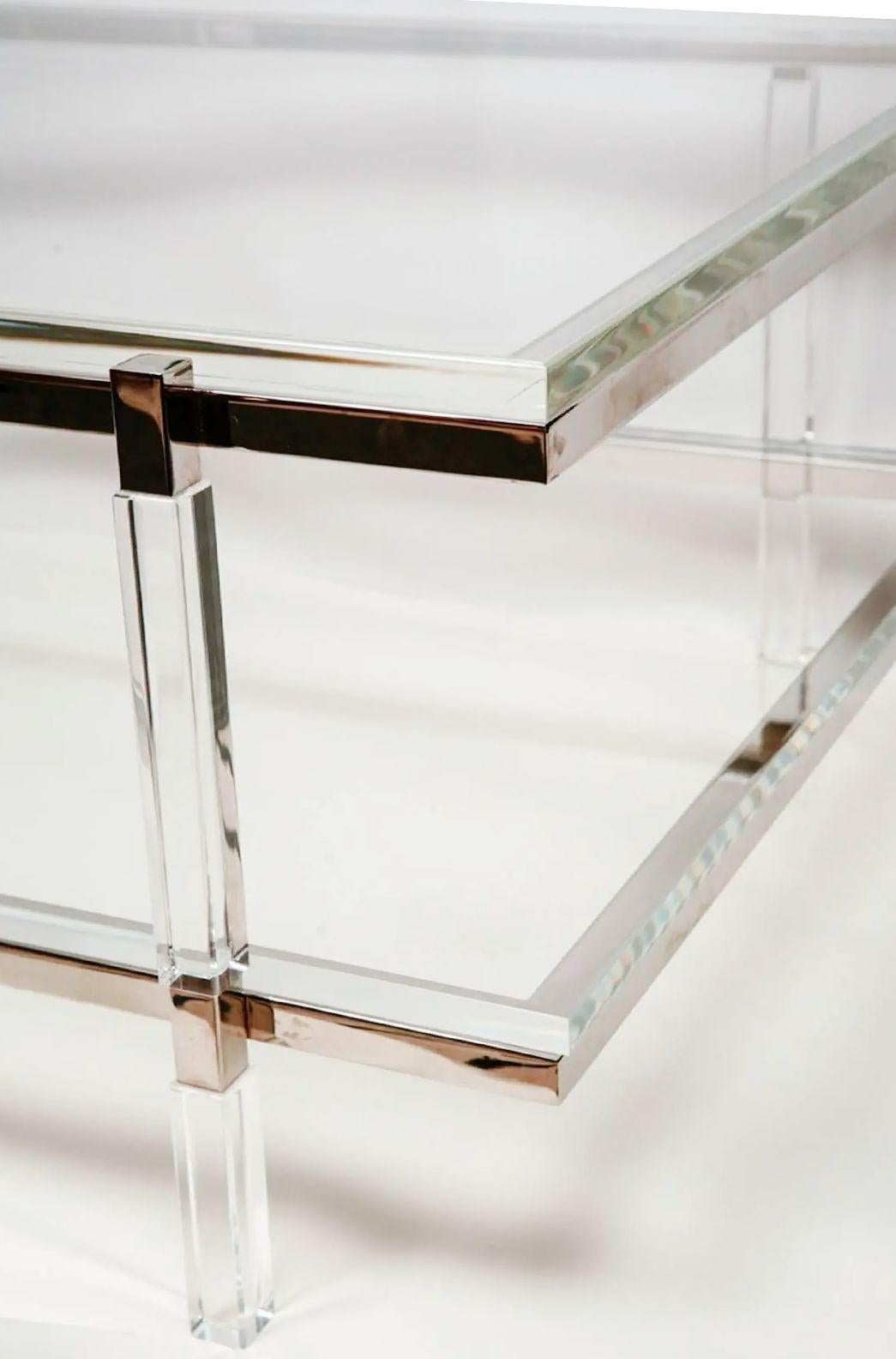 Vintage Two-tier lucite coffee table with chrome frame and details by Charles Hollis Jones for his Metric Collection designed in 1960's. The table's most striking feature is its elegant use of lucite, a material known for its transparency and
