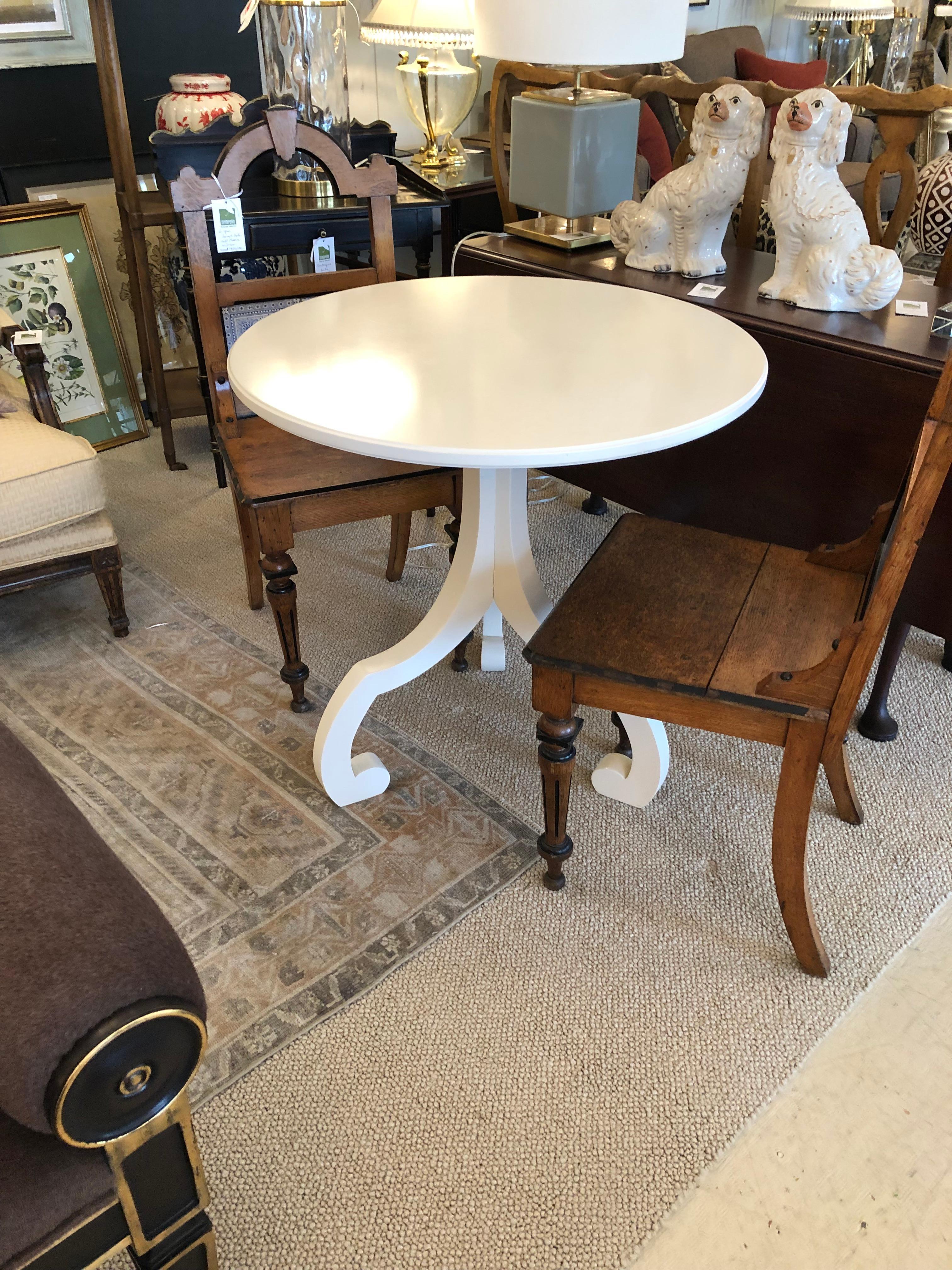 Chic round white small dining table having fashionable tripod base. Great size for a breakfast table.