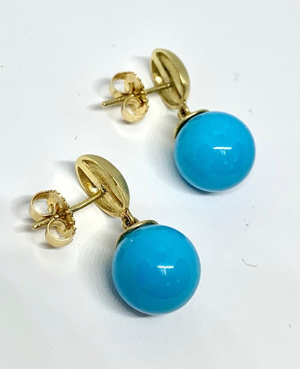 Turquoise doesn't come better than this! These beautiful earrings are made of fine quality Sleeping Beauty turquoise, which is very rare, as the mine has been closed for many years. Each turquoise sphere measures 11 millimeters and is suspended from
