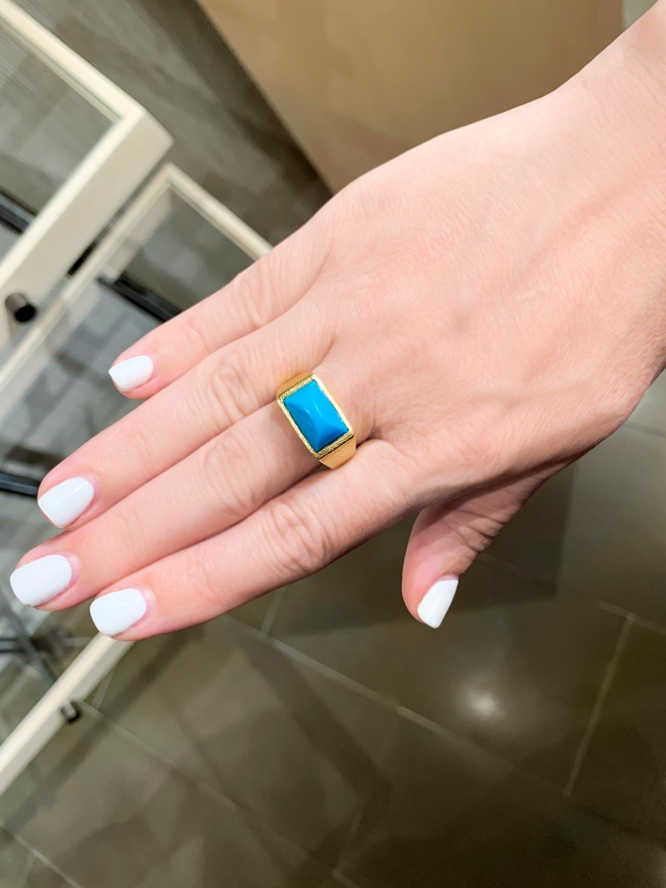 Hot off the bench! One of a Kind Signet Ring handcrafted by acclaimed jewelry maker Devta Doolan in the artist's intricately-textured and signature finished 18k yellow gold showcasing a gorgeous Sleeping Beauty turquoise domed cabochon, bezel-set