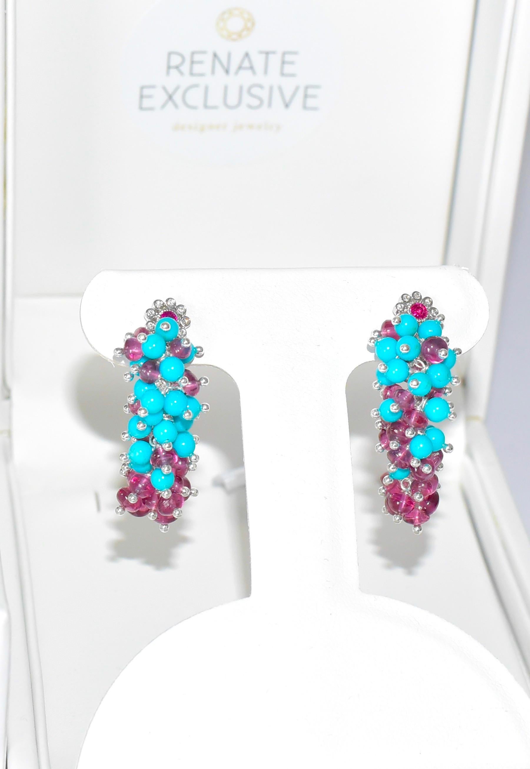 Tens and tens of Sleeping Beauty Turquoise beads have been painstakingly hand-linked along with Malawi Rhodolite Garnet beads. Amazing luxe-style earrings with extraordinary 14K solid white gold diamond flower ear posts with Ruby centers and bezel