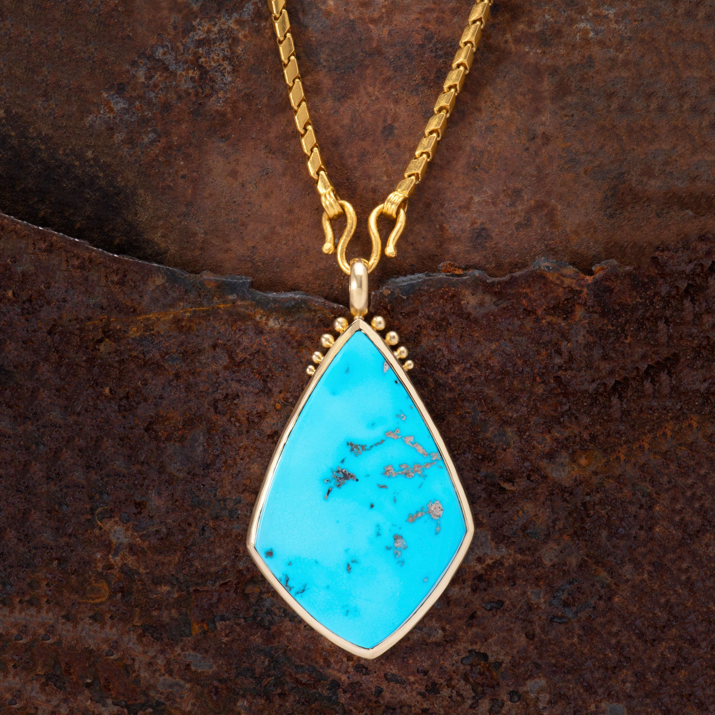 A classic, bright cabochon of Sleeping Beauty Turquoise weighing 120 carats is peppered with pale silvery and mocha colored matrix. Turquoise from the Sleeping Beauty Mine in Arizona is renowned for it's clarity and sky blue color. This striking
