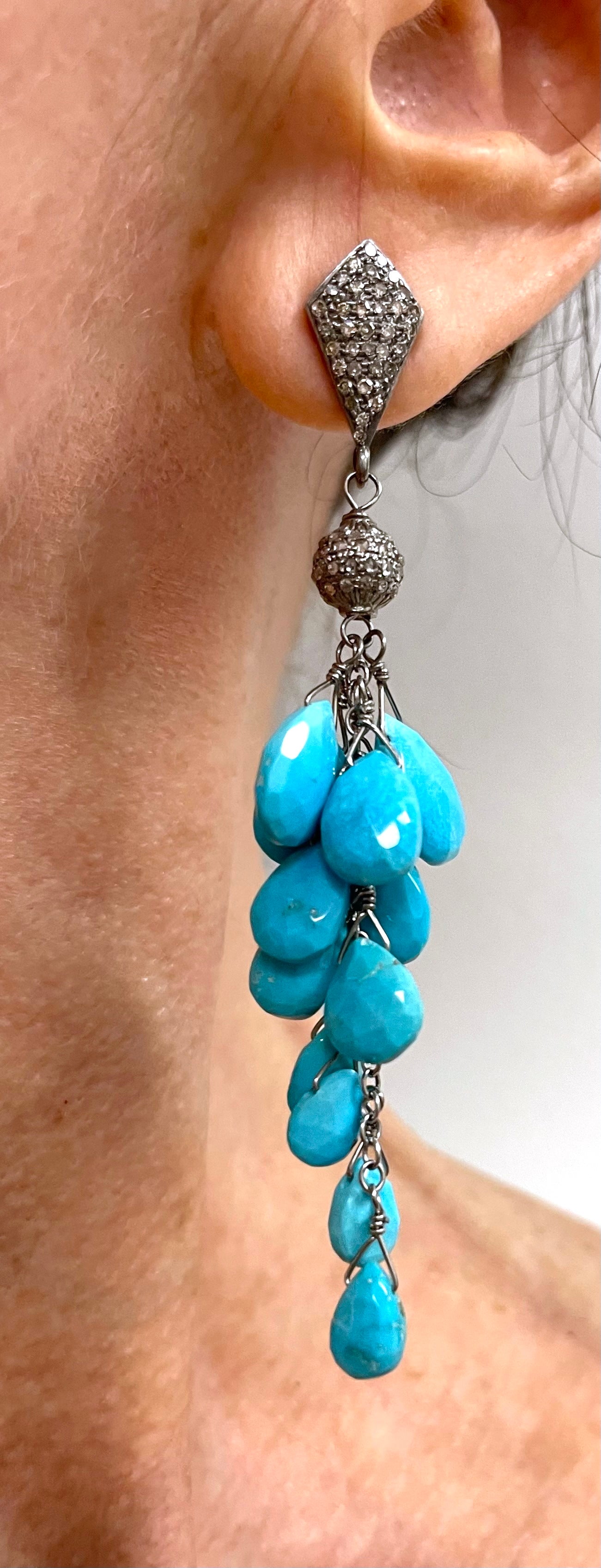 Description
Vivid and strikingly beautiful Sleeping Beauty turquoise, individually wire wrapped creating a cascading cluster, crowned with pave diamond studs for an overall harmonious and feminine style.
Item # E3357

Materials and Weight
Sleeping
