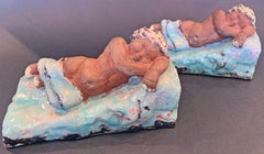 Sleeping Child Bookends, Probably Viennese, with Pale Blue and Yellow Glazes