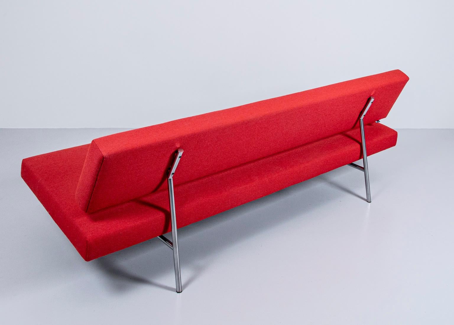 This is a beautiful, iconic Dutch design sofa by Martin Visser (designed in 1950s). The sofa has a square chrome metal frame, contrasting very nicely to the red wool upholstery. The backrest can be easily moved down so that the sofa becomes a daybed