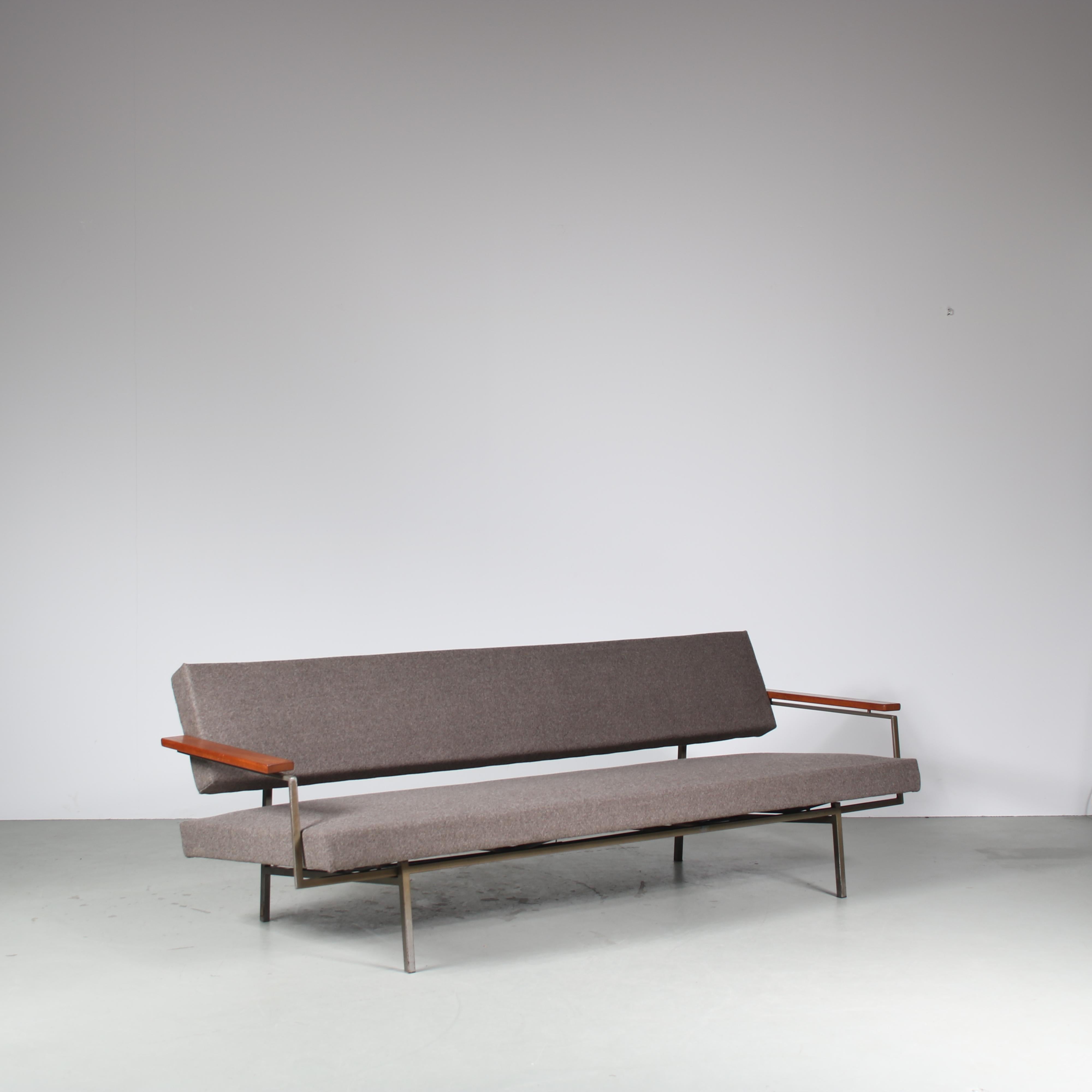 A luxurious sleeping sofa designed by Rob Parry, manufactured by Gelderland in the Netherlands around 1960.

This eye-catching sofa has a beautiful steel base, warm brown wooden armrests and is newly upholstered in high quality grey fabric. This