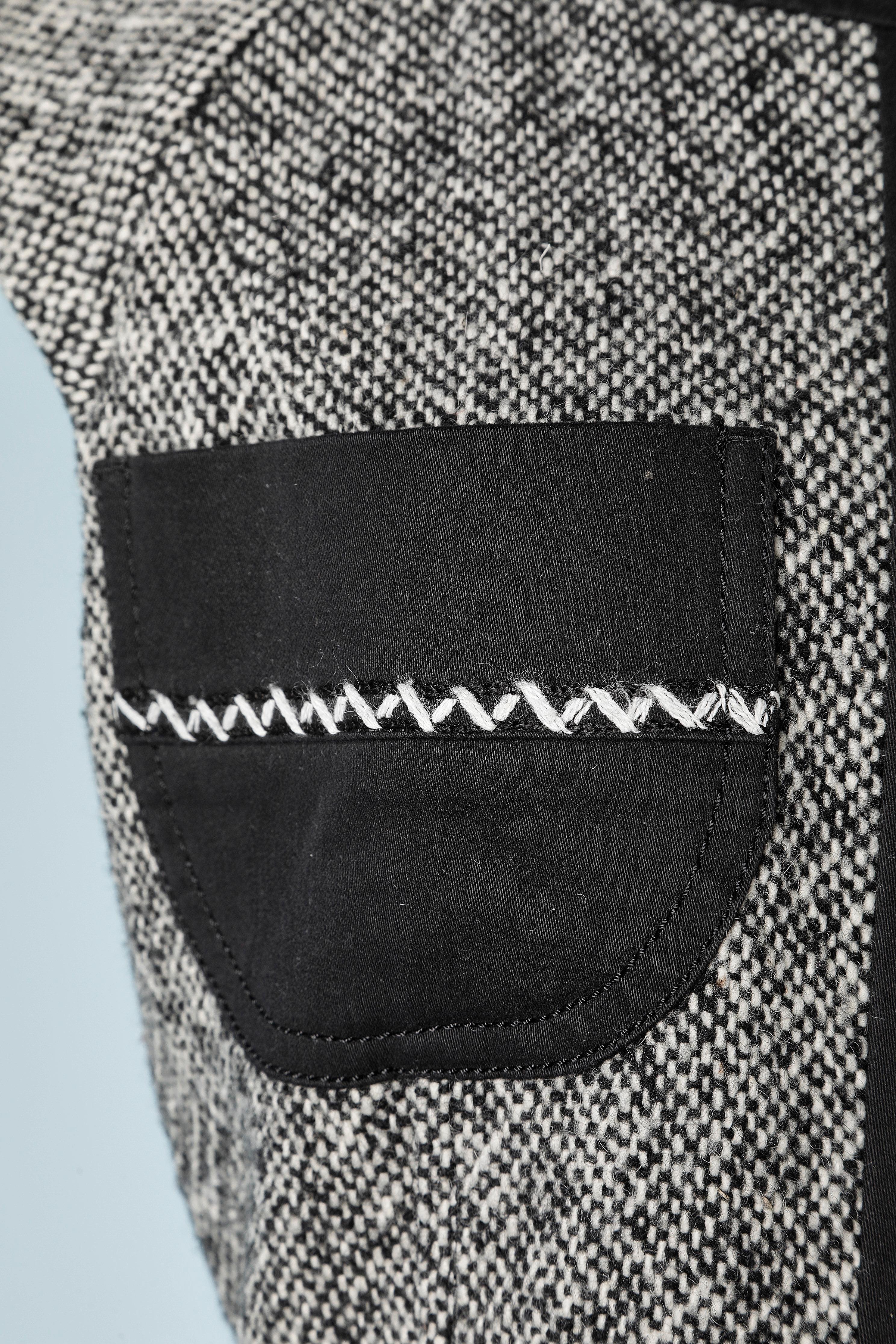 Sleeveless black and white tweed dress with black cotton pockets and waistband. 
Top -stitched.