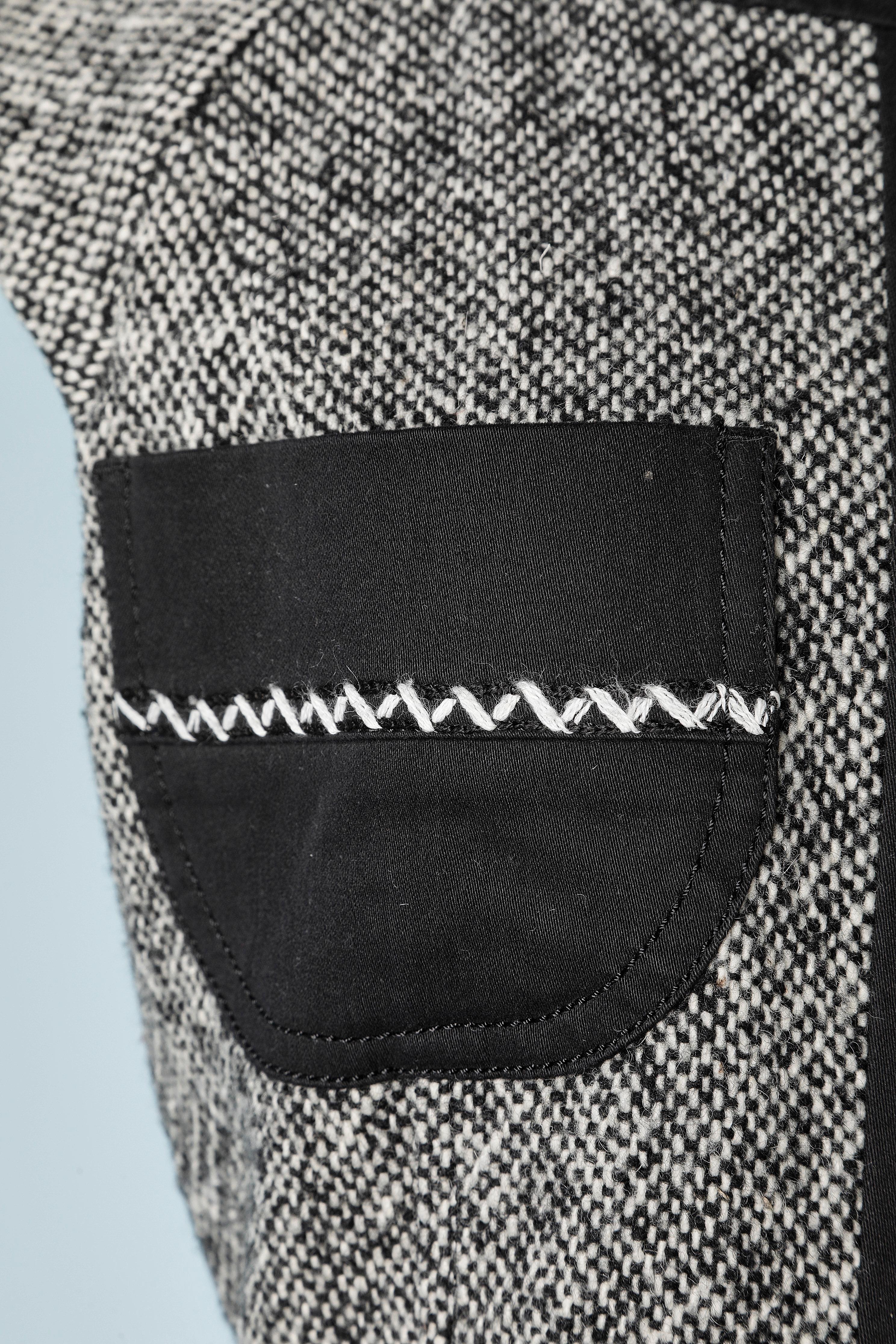 Robe sans manches en tweed noir et blanc avec poches et ceinture en coton noir. 
Surpiqûre.