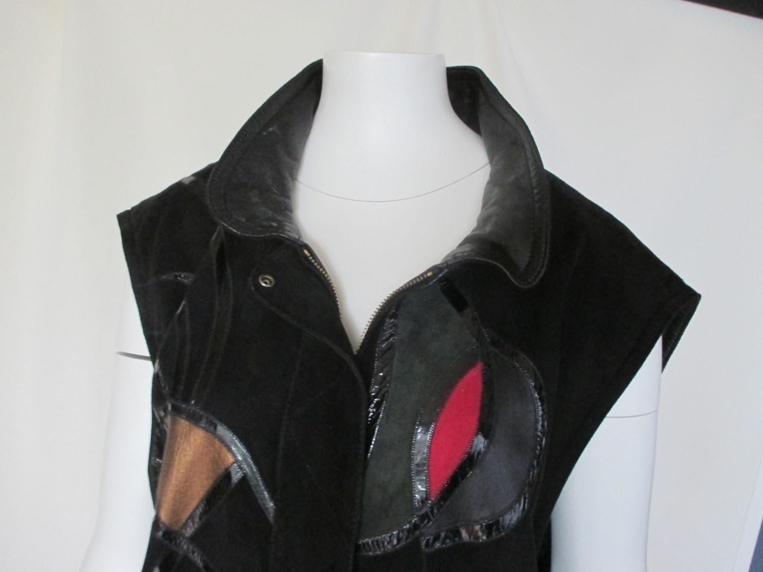 Vintage 1980 unique sleeveless suede art leather vest.

We offer more luxury fur and leather items, view our frontstore.

Details:
This coat is made of a very soft calfskin suede leather and finished in beautiful colored leather patchwork art